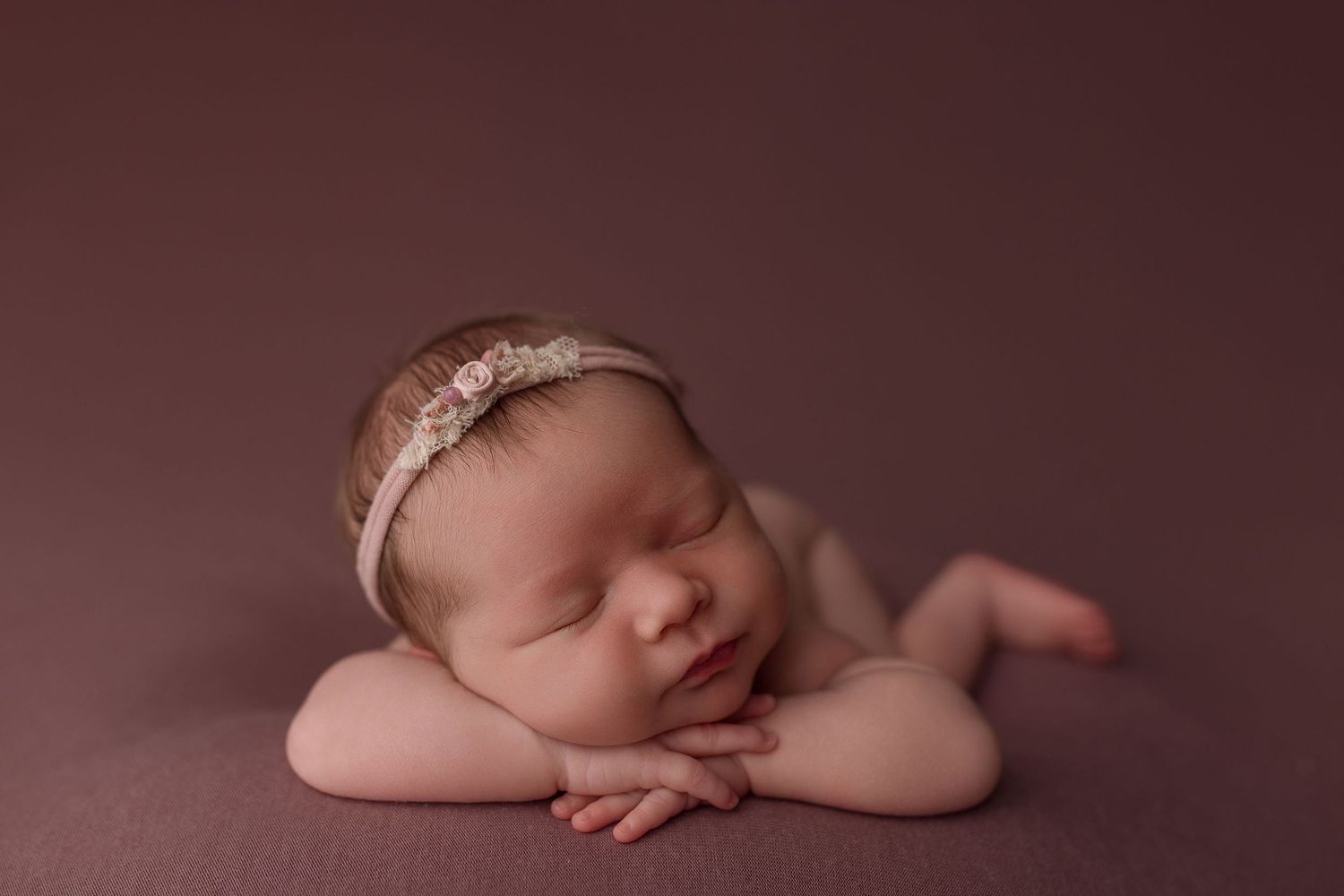Baby girl during newborn session with Bree Elle Photography in Port Neches, TX studio.