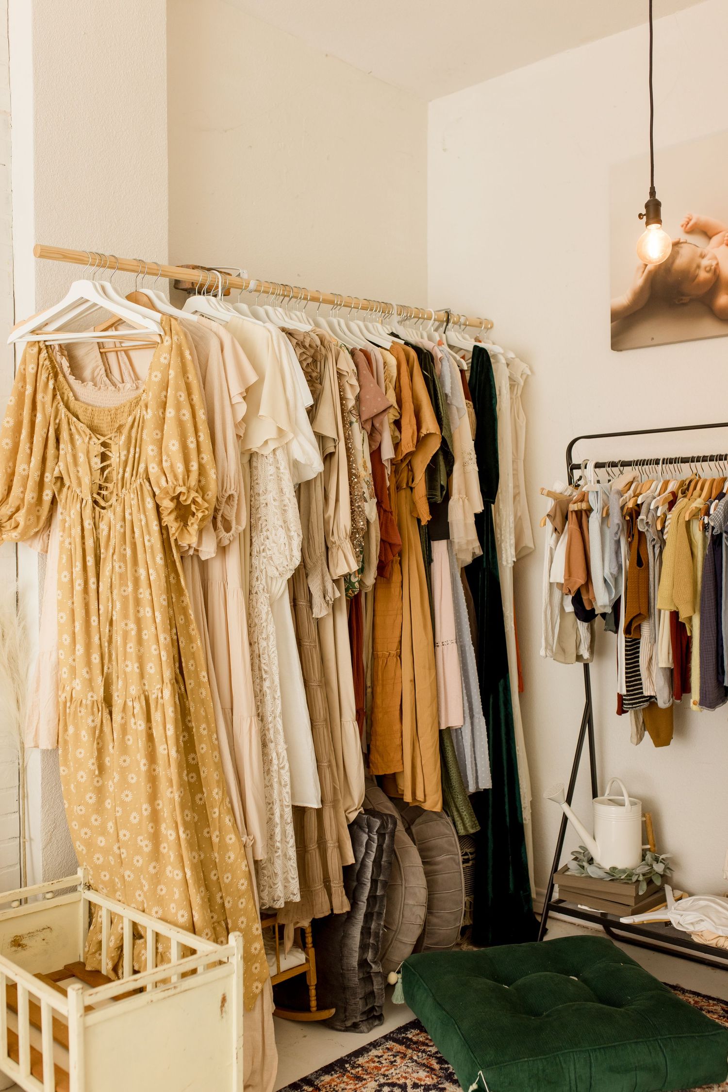Clothing rack displaying boho-style dresses and garments in neutral earth tones.