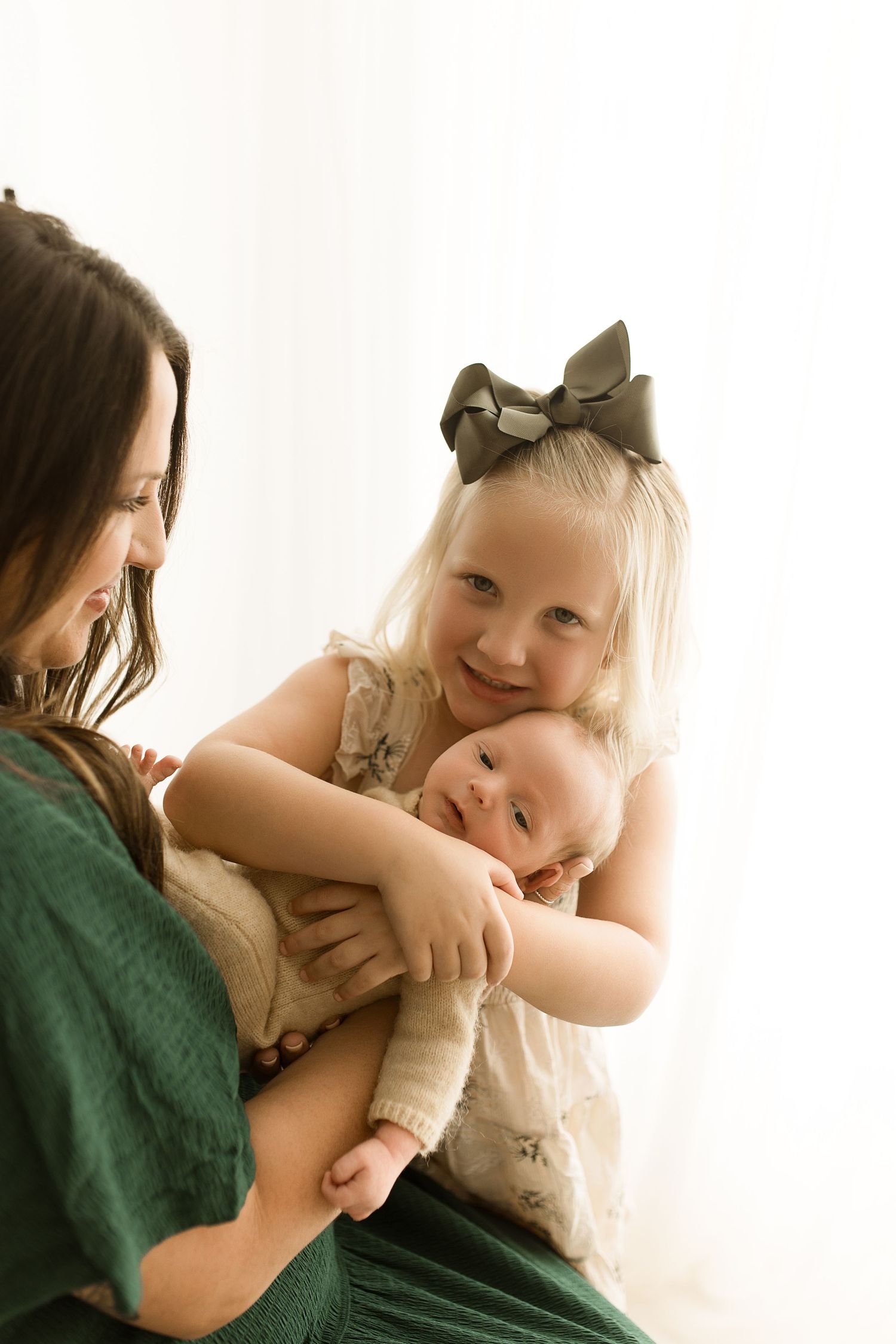 Tender lifestyle portrait of parent and child sharing intimate moment against white background.
