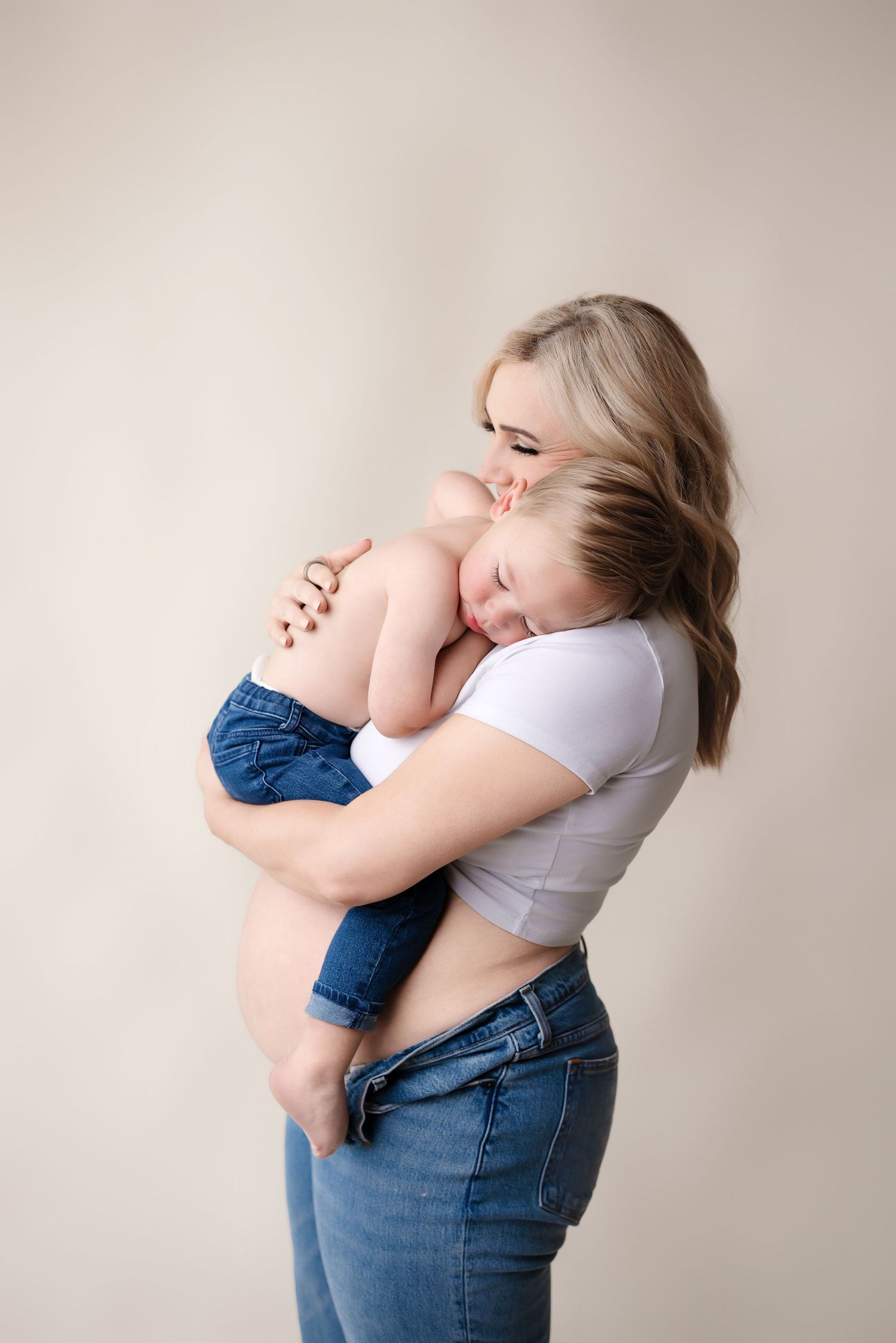 A tender moment captured between parent and child against a neutral studio backdrop with Bree Elle Photography in Beaumont, TX.