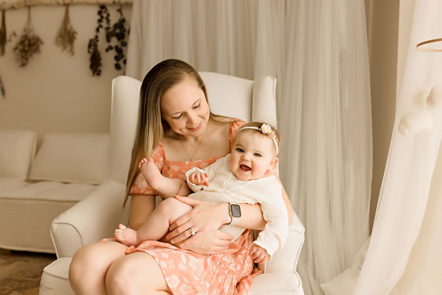 Soft and intimate family photography session with white curtain backdrop.
