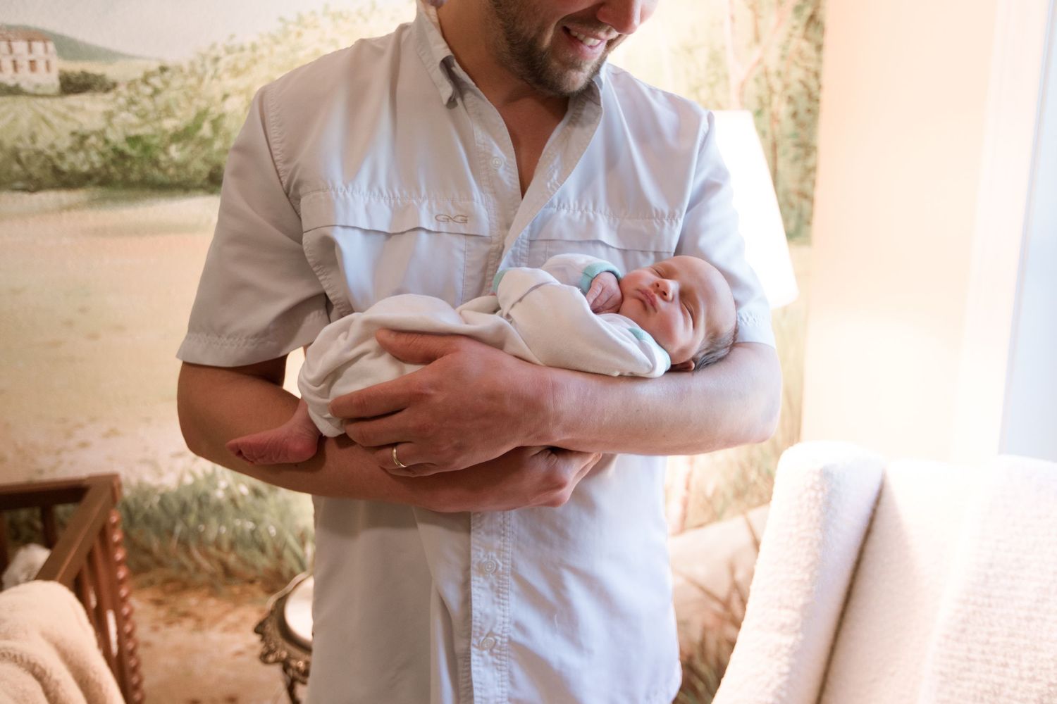 Dad and baby during a Fresh 48 nursery session in Beaumont.