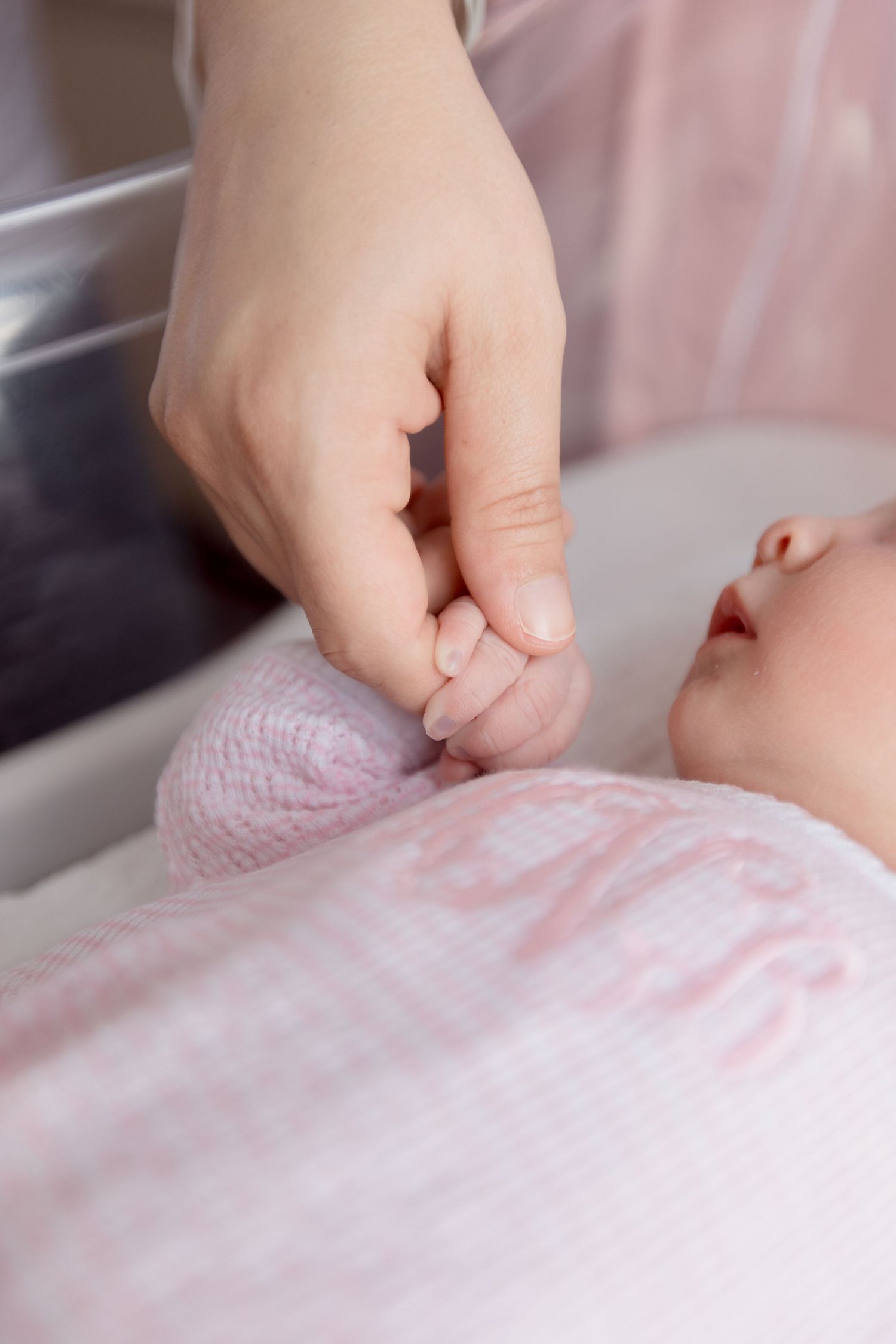 Close-up view of mother and newborn hands during Fresh 48 session in Beaumont hospital.