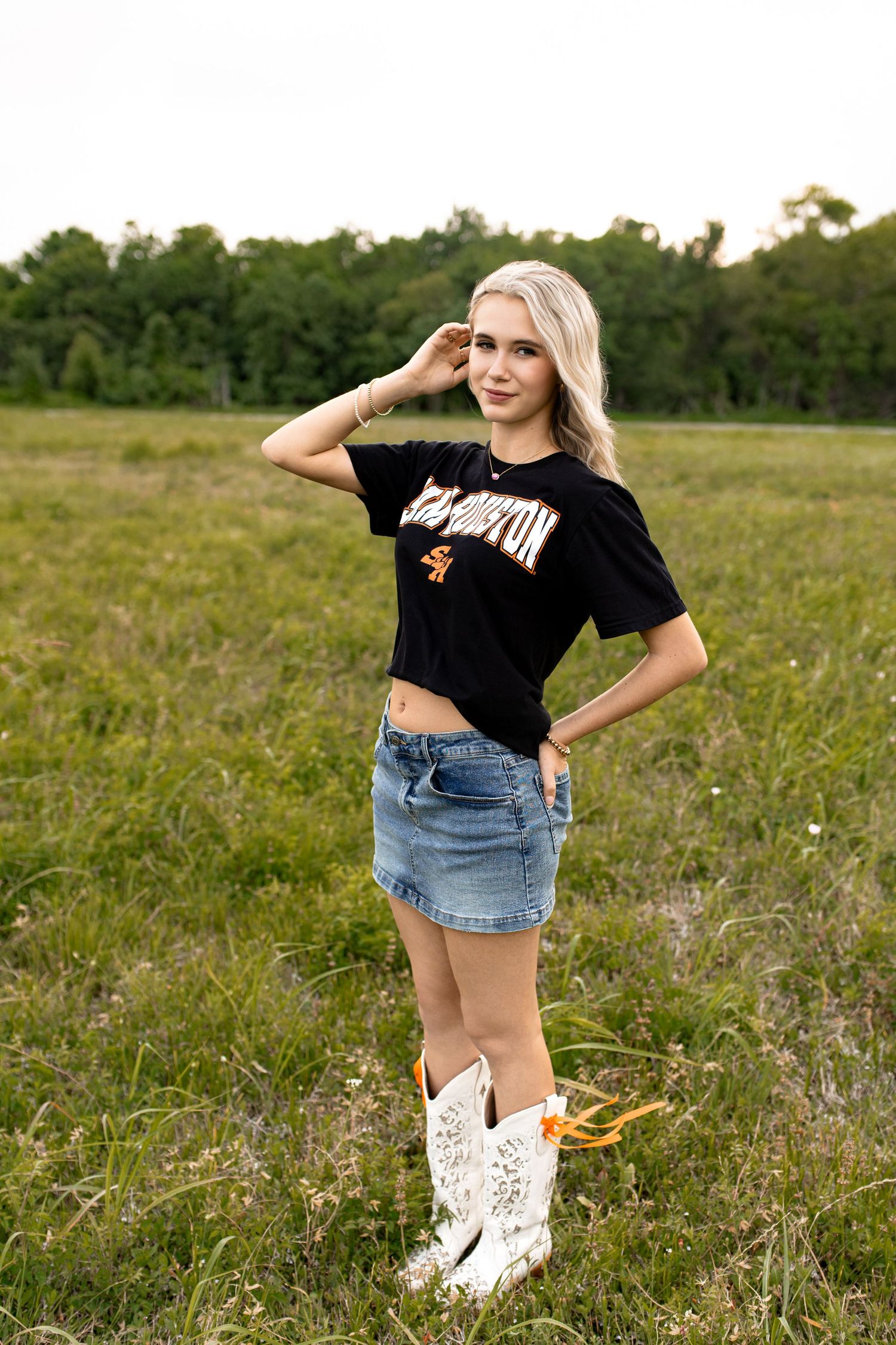 College tee senior session with Bree Elle Photography Seniors in a field in Beaumont, TX.