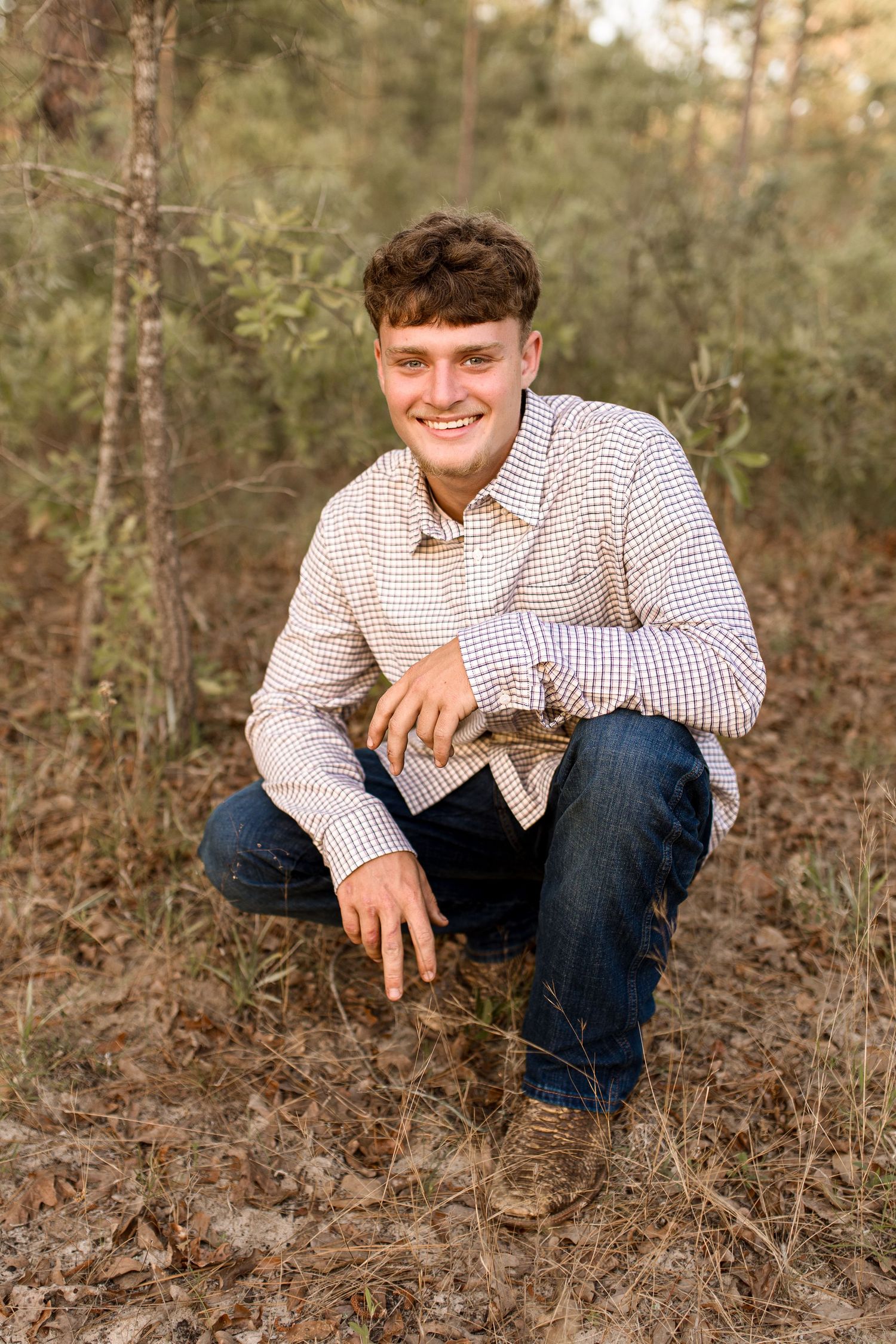 Bree Elle Photography by Alicia Stephenson with graduating senior boy in a field in Silsbee, TX.