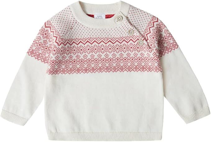 White baby sweater with red Nordic fair isle pattern across chest and shoulder button closure.