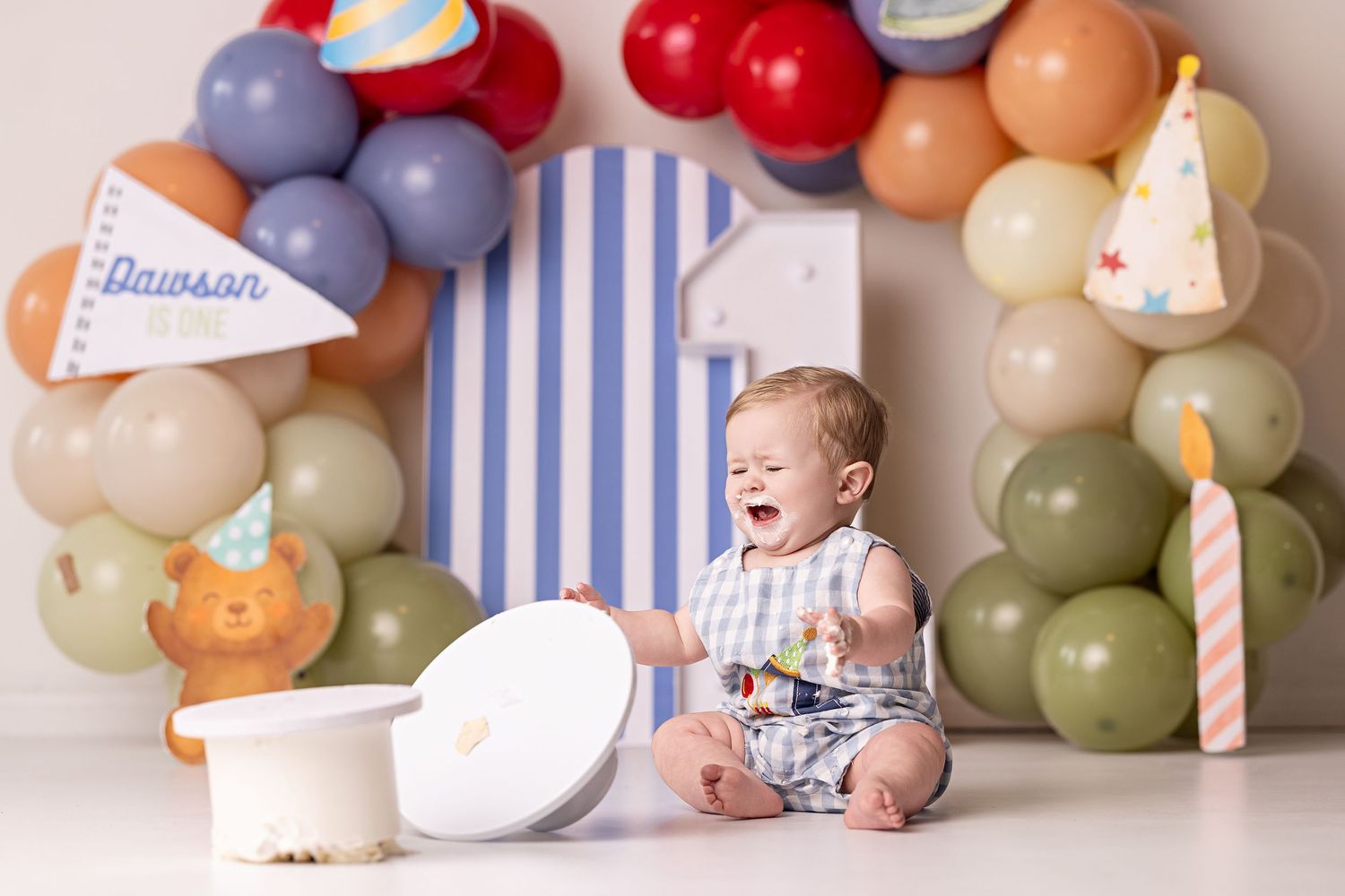 A series of baby milestone photos with pastel balloons and striped backgrounds showing monthly growth progression.