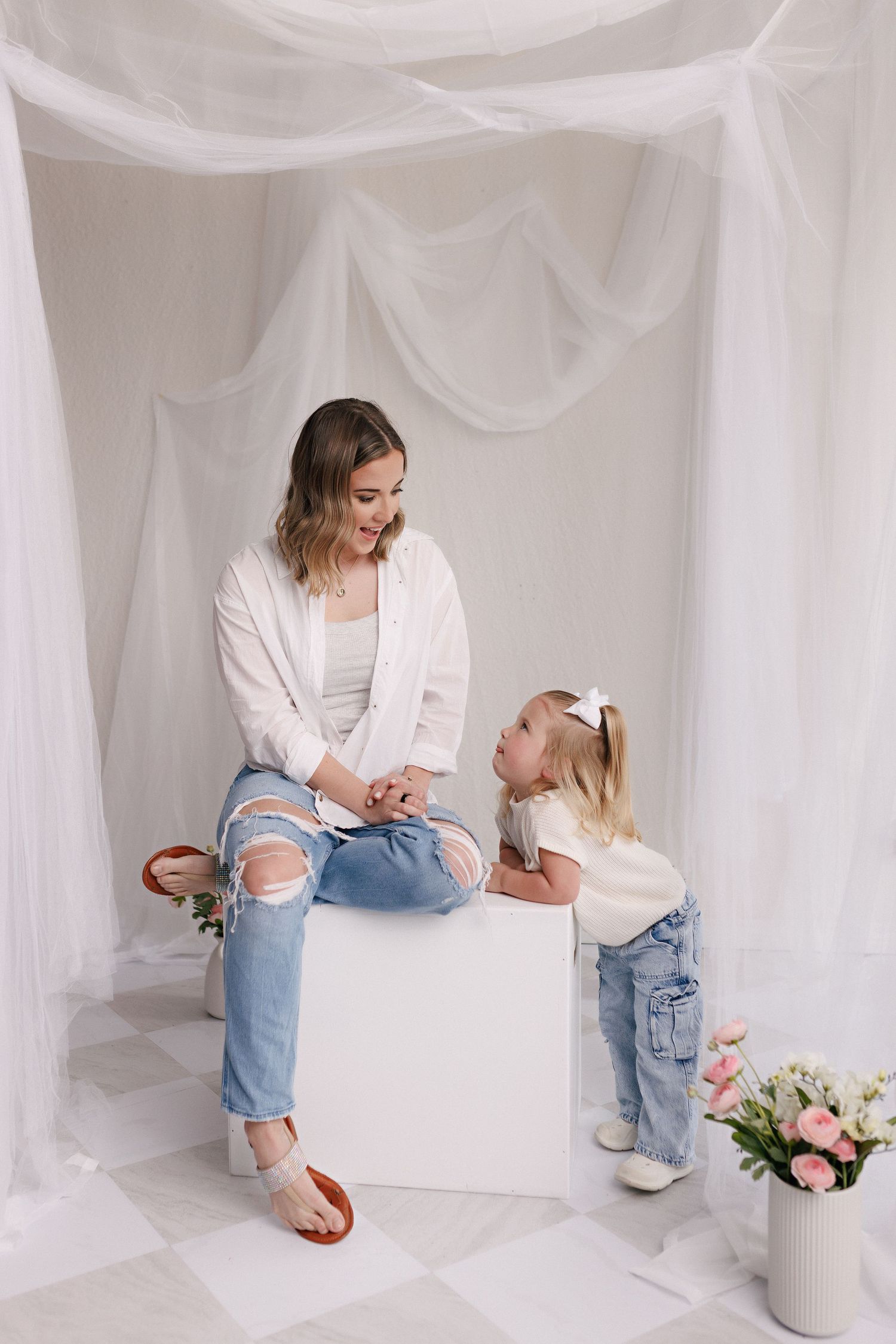 Parent and toddler in matching white tops and jeans during mommy and me session with Bree Elle Photography in Port Neches, TX.