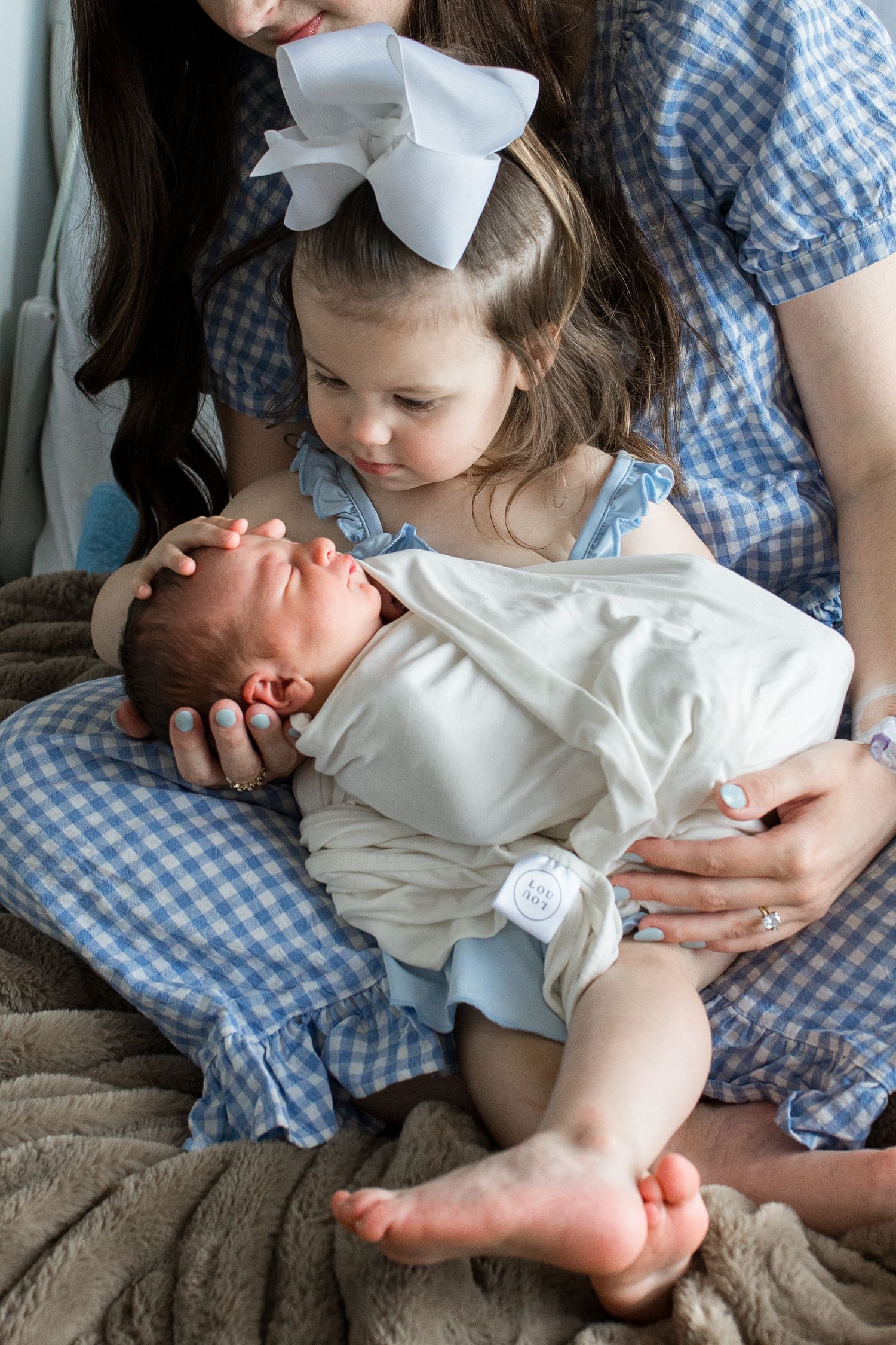 Newborn baby and sibling during Fresh 48 session at St. Elizabeth Hospital in Beaumont, TX. Photographed by Bree Elle Photography.
