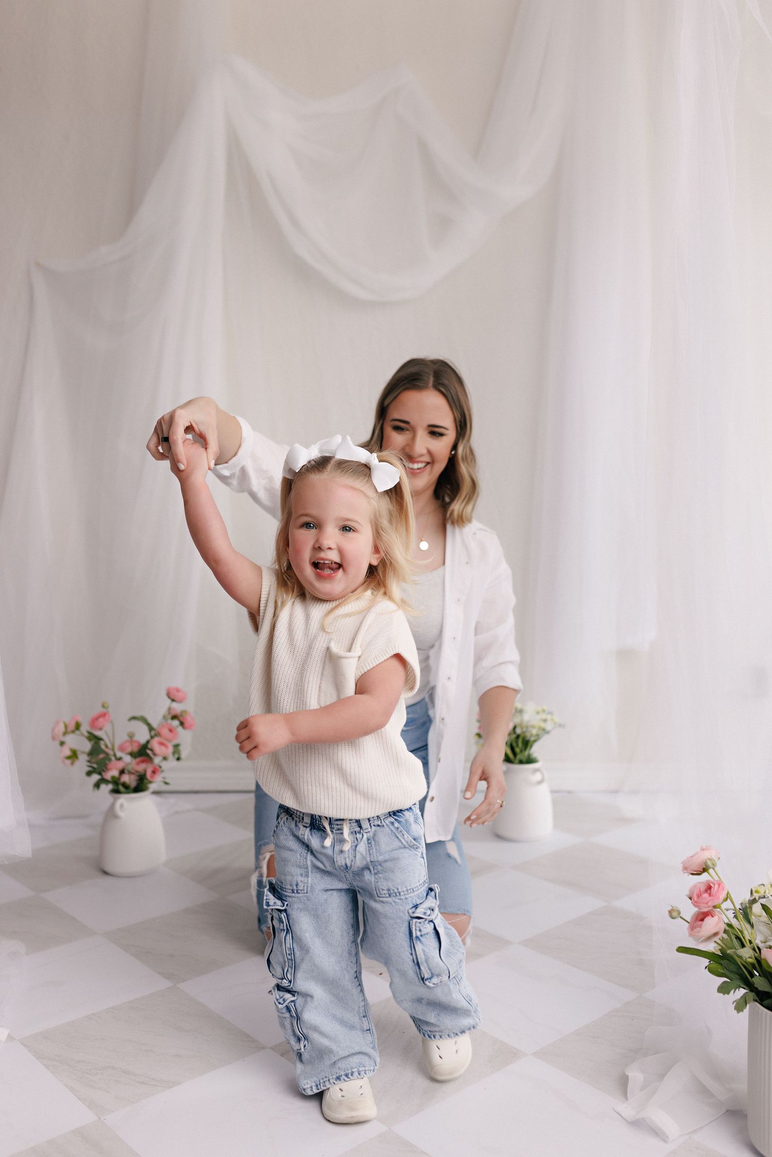 Parent and toddler in matching white tops and jeans during mommy and me session with Bree Elle Photography in Port Neches, TX.