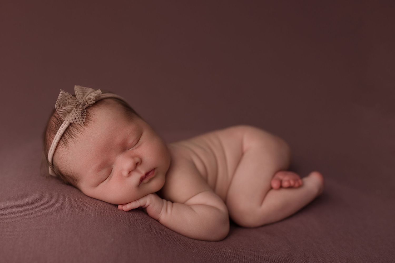 Baby girl during newborn session with Bree Elle Photography in Beaumont, TX.