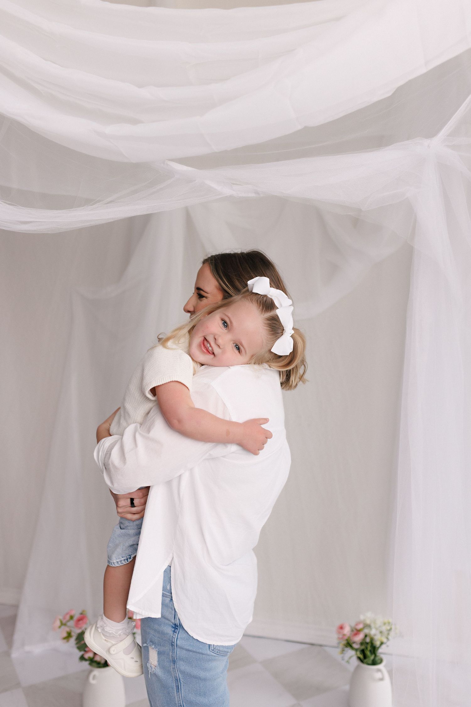 Parent and toddler in matching white tops and jeans during mommy and me session with Bree Elle Photography in Port Neches, TX.