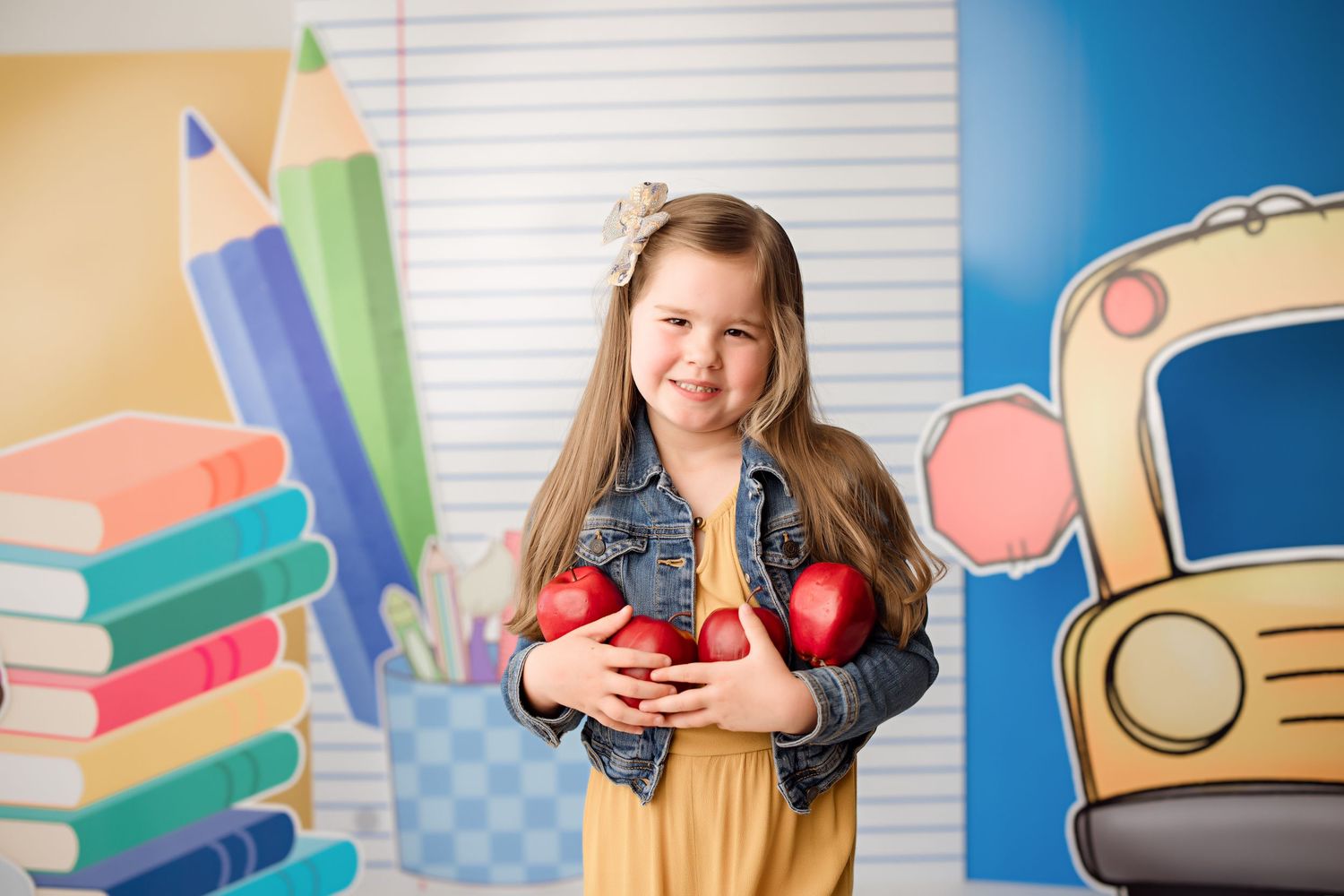 Colorful classroom backdrop with school bus and pencil designs features educational props and decorations.