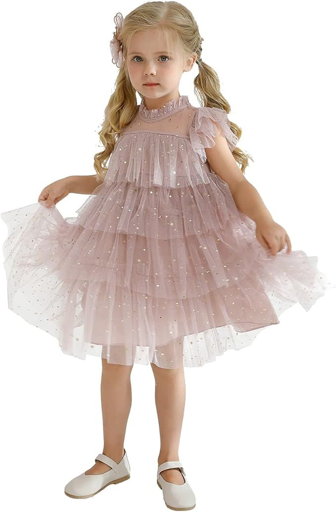 A small child wearing a sparkly pink tulle dress and white shoes poses in multiple identical views of the same outfit.