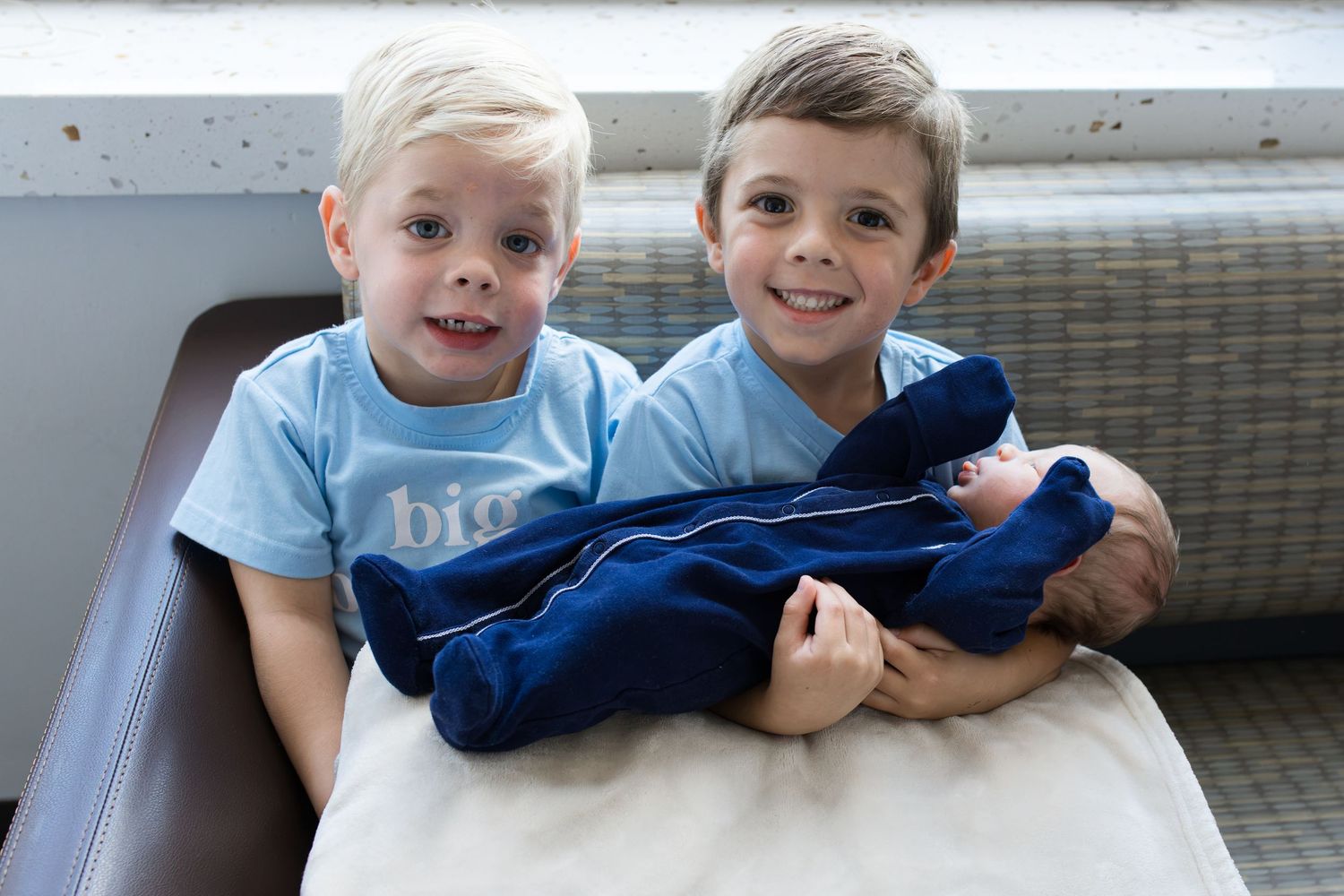 Older brothers meeting their newborn baby during Fresh 48 session in Beaumont, TX at St. Elizabeth with Bree Elle Photography.