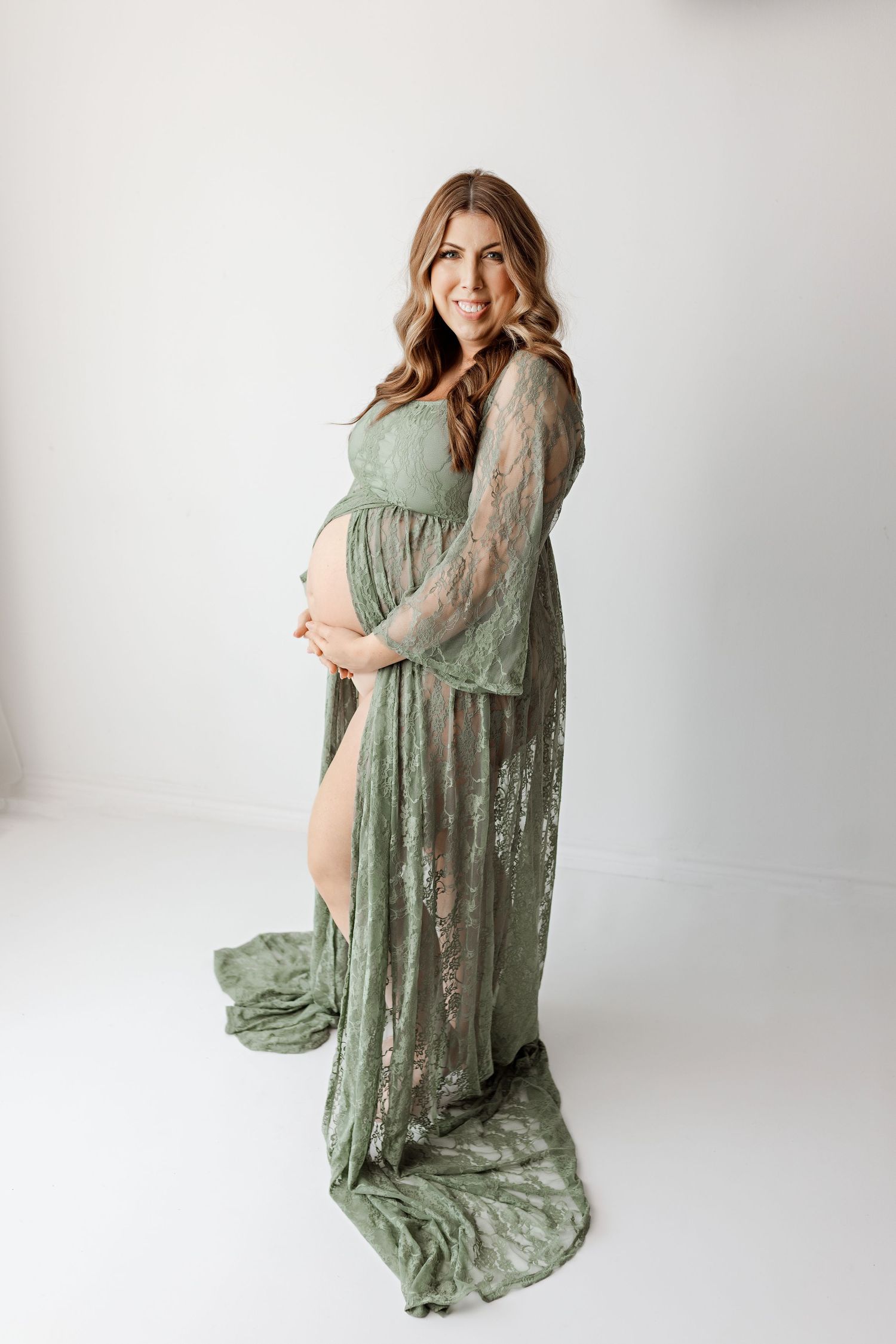 Dramatic maternity portrait in flowing sage green lace gown with train with Bree Elle Photography in Southeast, TX.