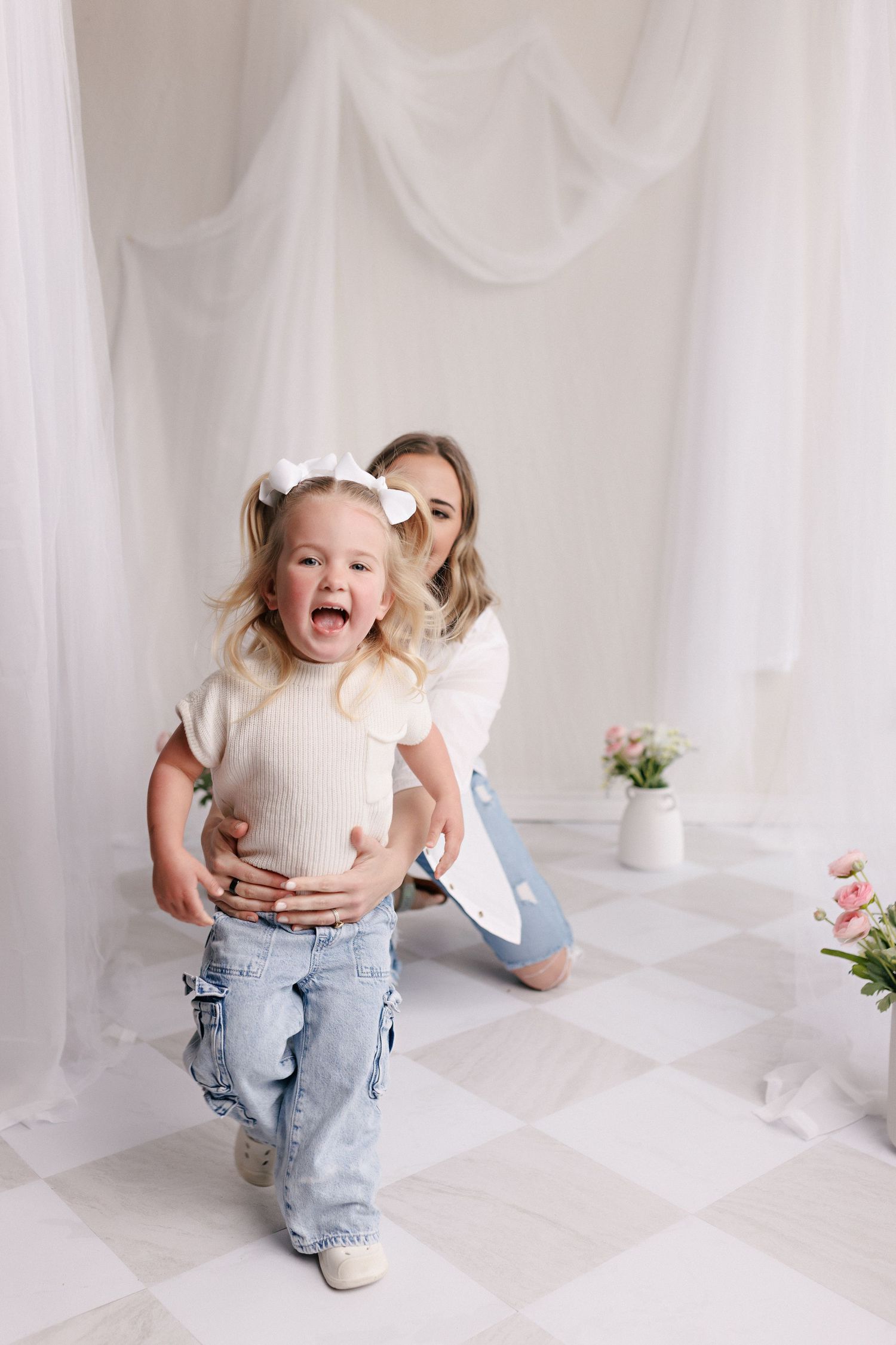 Parent and toddler in matching white tops and jeans during mommy and me session with Bree Elle Photography in Port Neches, TX.