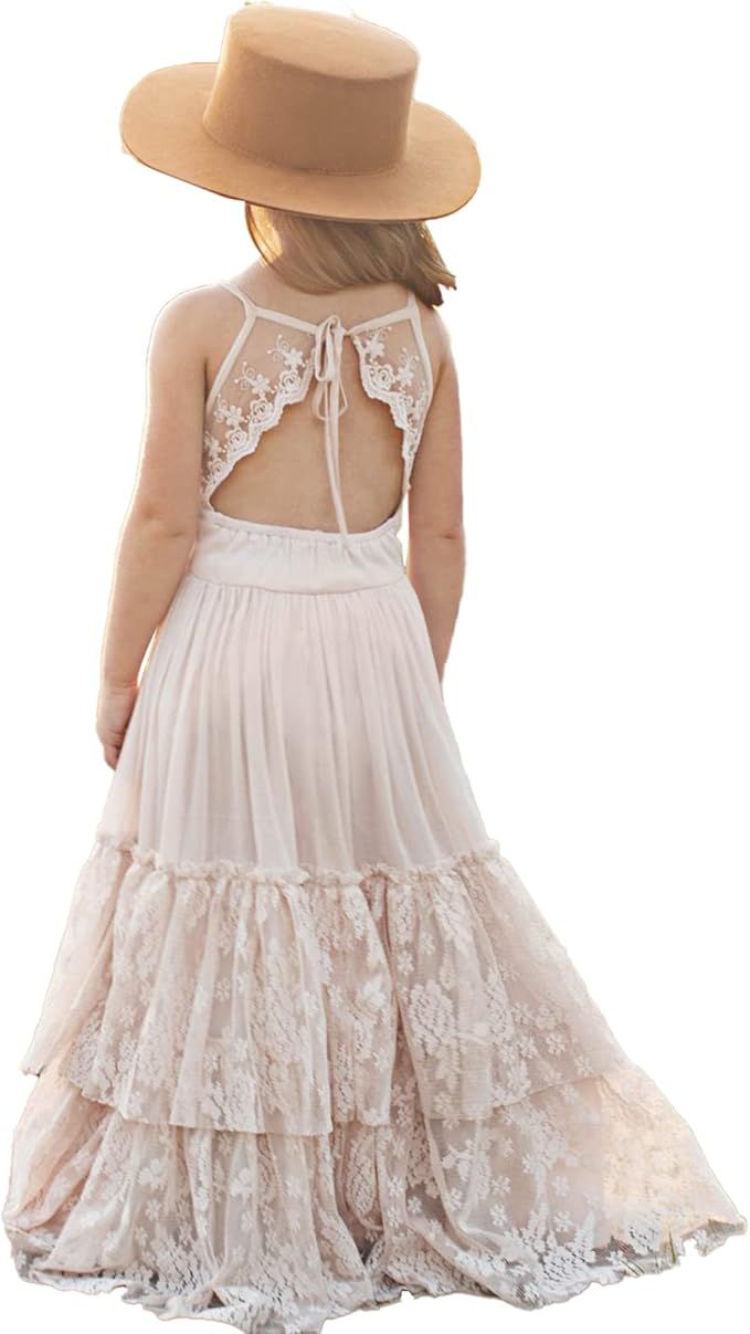 A bohemian style floor-length white lace dress with open back detail and tan sun hat shown from behind.