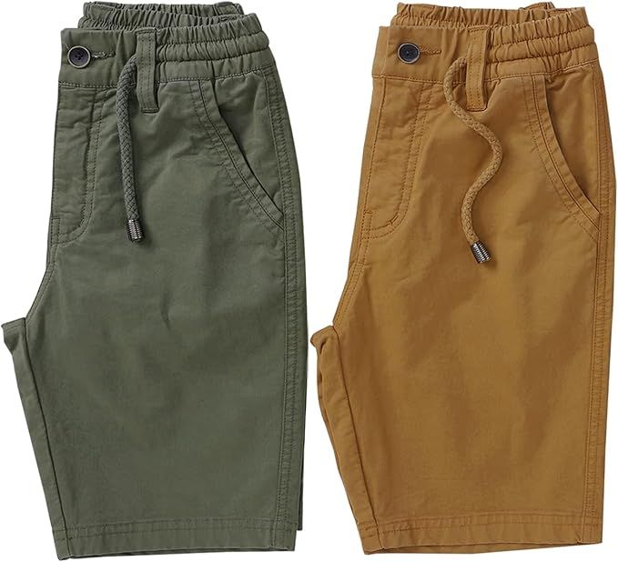 Folded casual pants in earth tone colors including olive green and brown displayed in a row.
