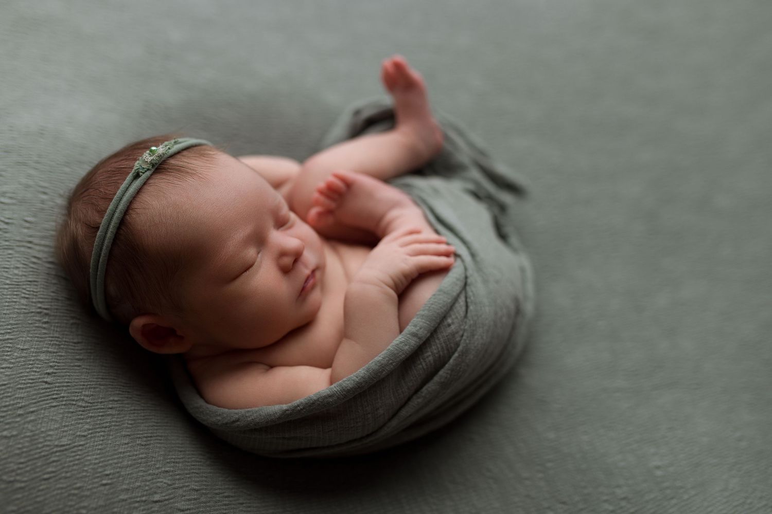 Baby girl during newborn session with Bree Elle Photography in Port Neches, TX studio.