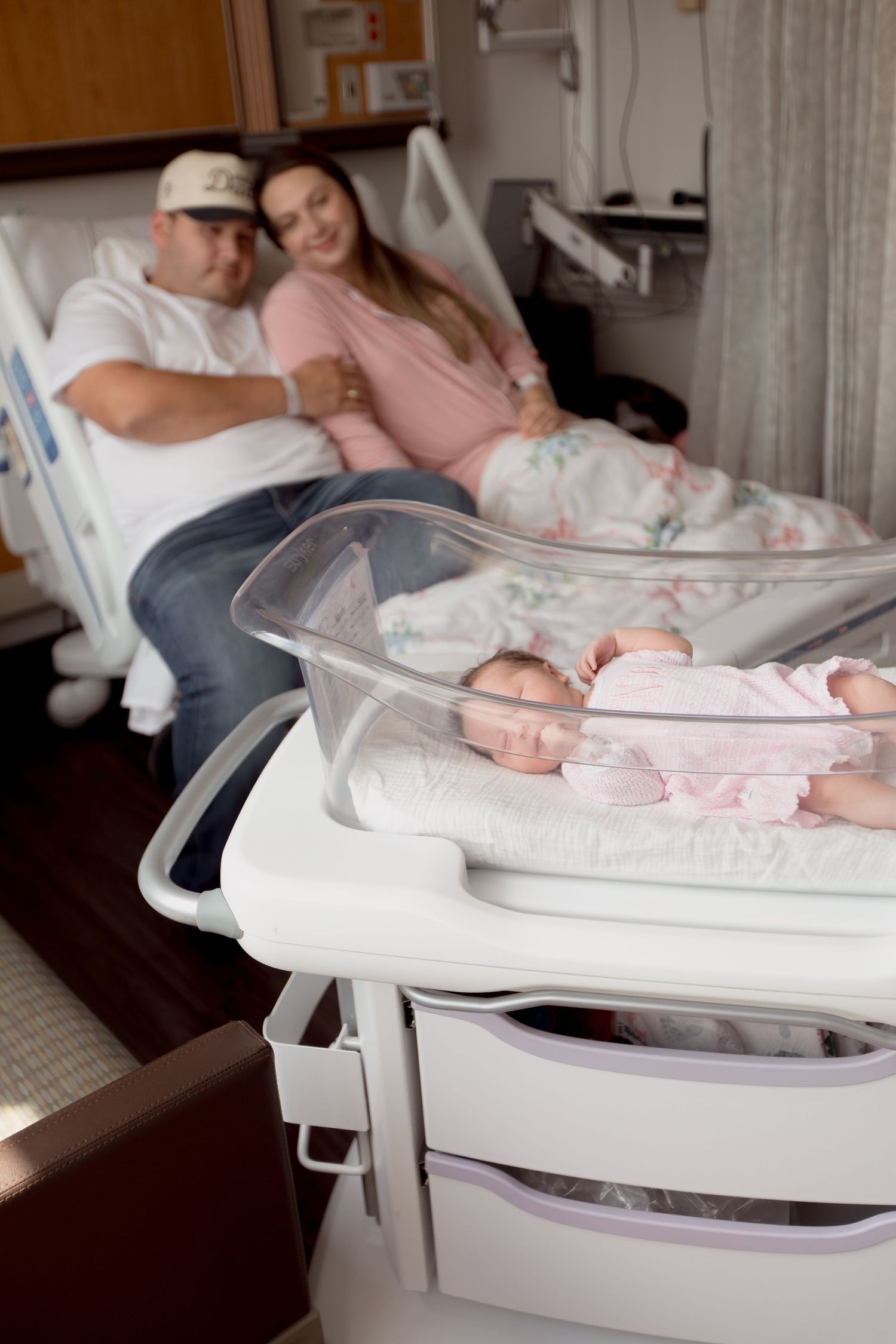 A newborn baby rests peacefully in a white hospital bassinet while being cared for during Fresh 48 session in Beaumont hospital.