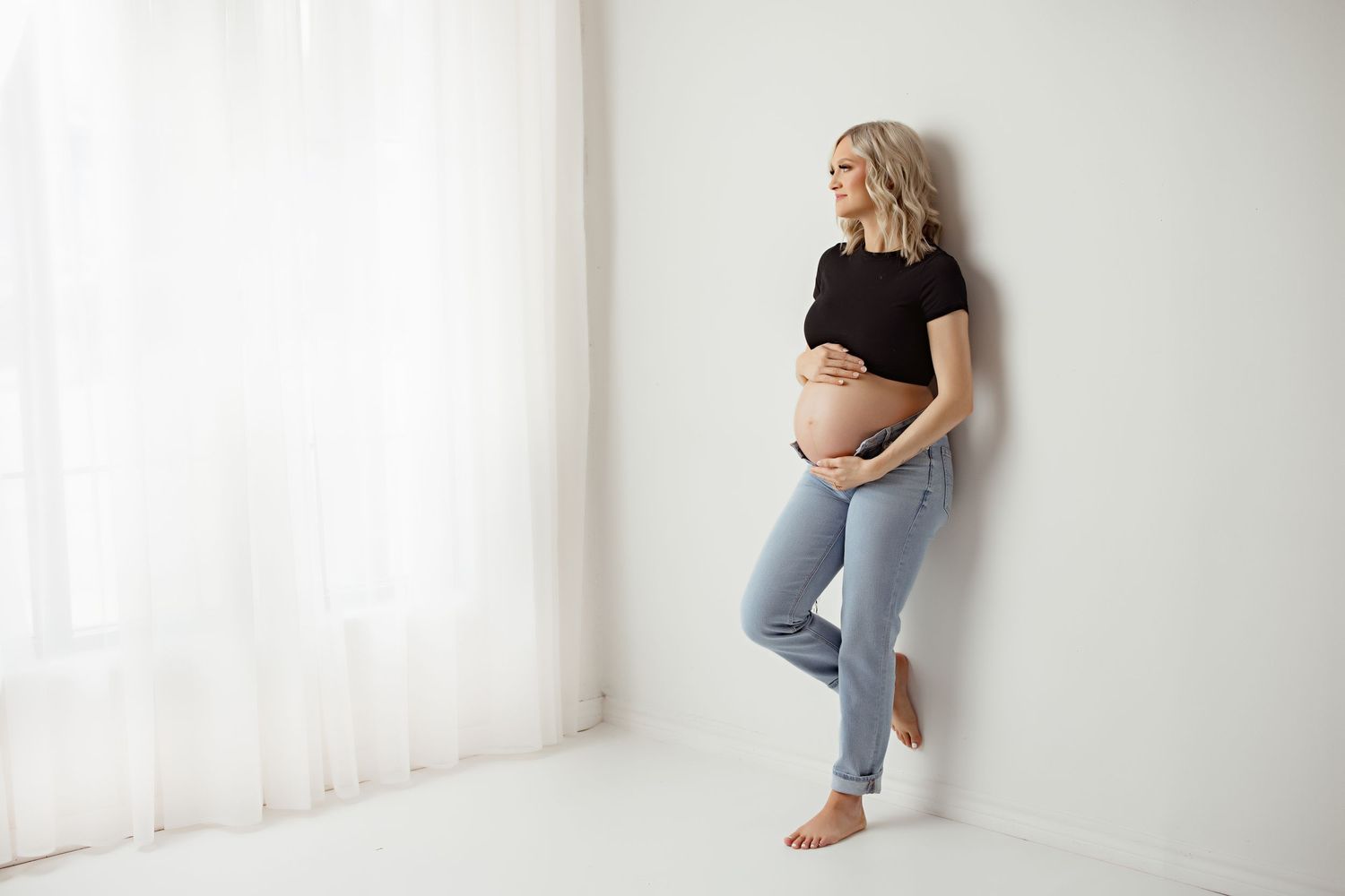 Minimalist maternity photos in white studio with soft natural light with Bree Elle Photography near me in Beaumont, TX.