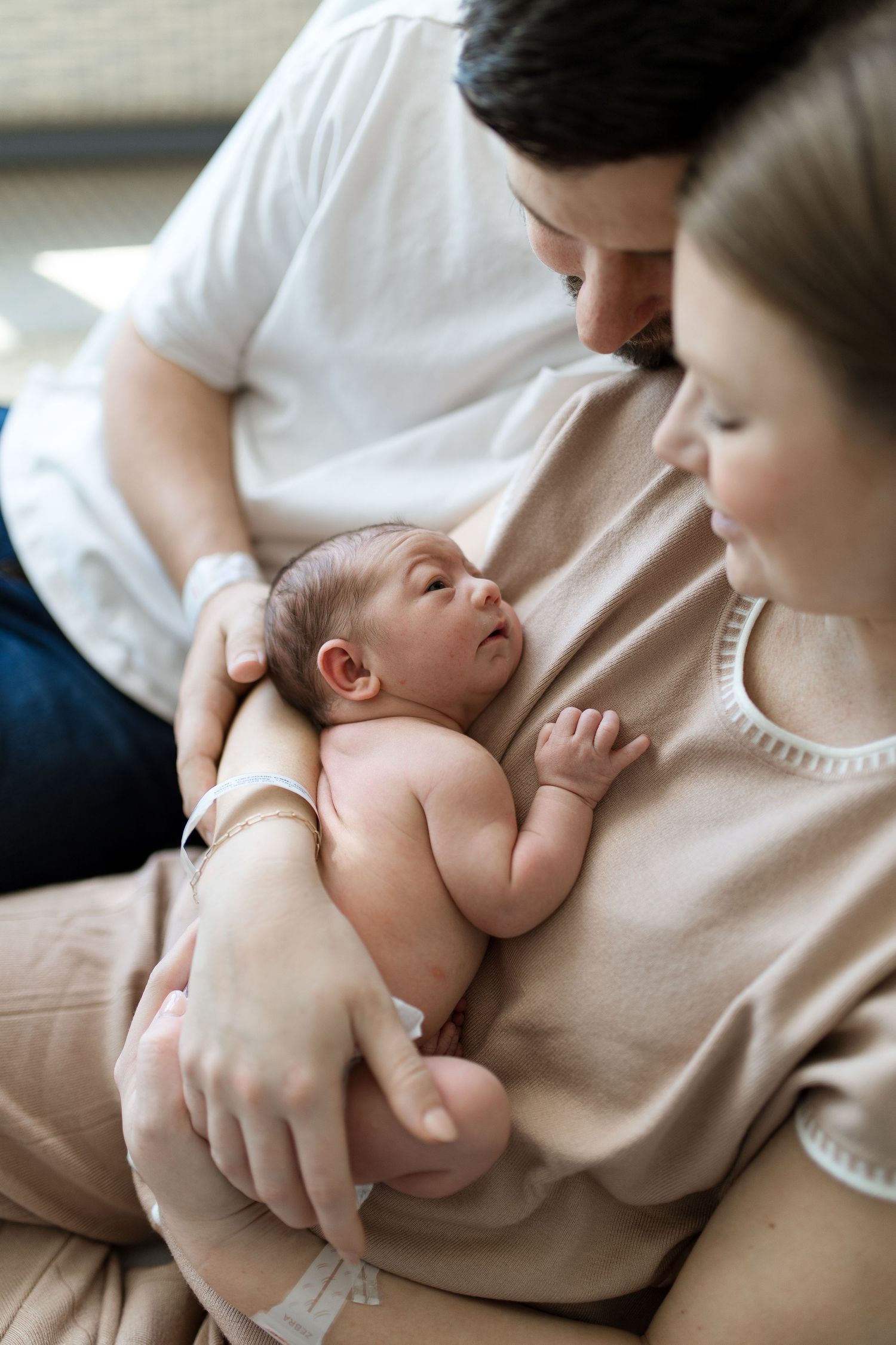 Parents holding baby during their Fresh 48 session with Bree Elle Photography in Beaumont, TX at St. Elizabeth hospital.