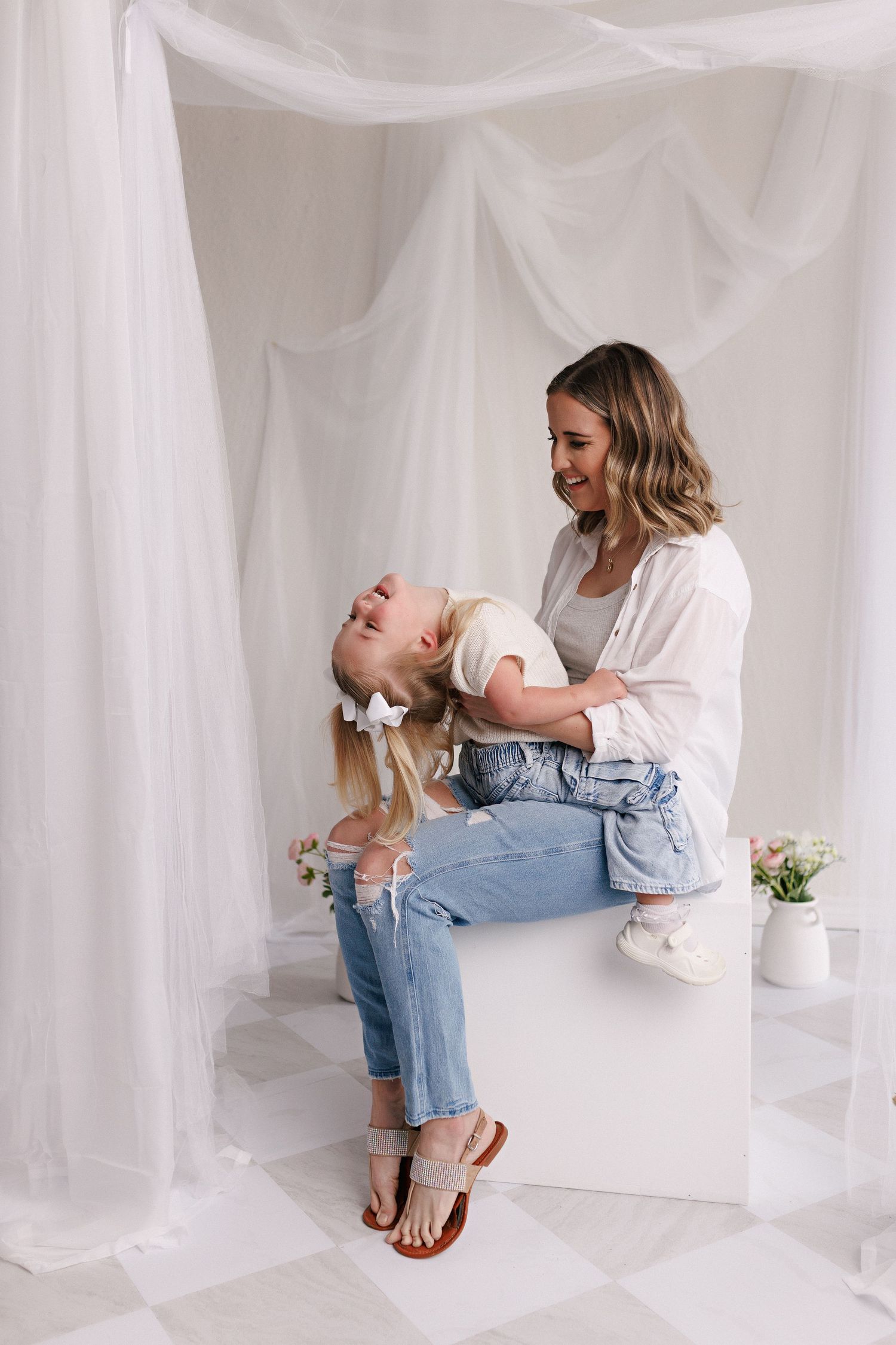 Parent and toddler in matching white tops and jeans during mommy and me session with Bree Elle Photography in Port Neches, TX.