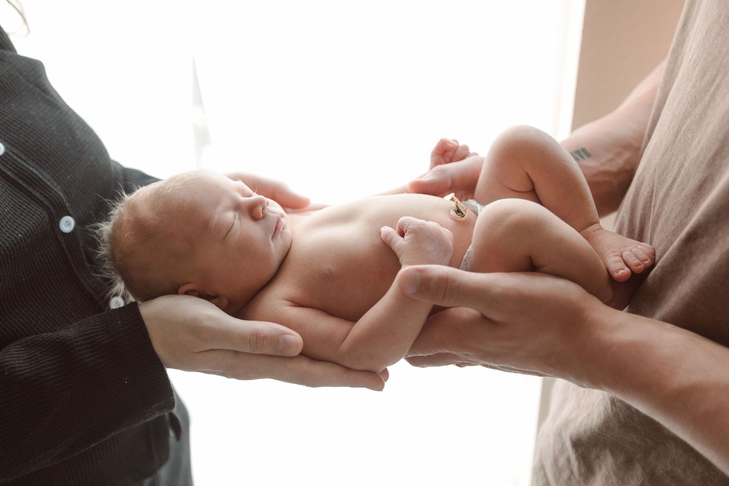 Parents holding baby during Fresh 48 nursery session in Bridge City.