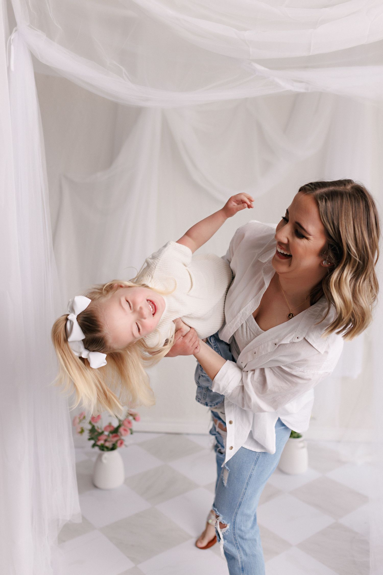 Parent and toddler in matching white tops and jeans during mommy and me session with Bree Elle Photography in Port Neches, TX.