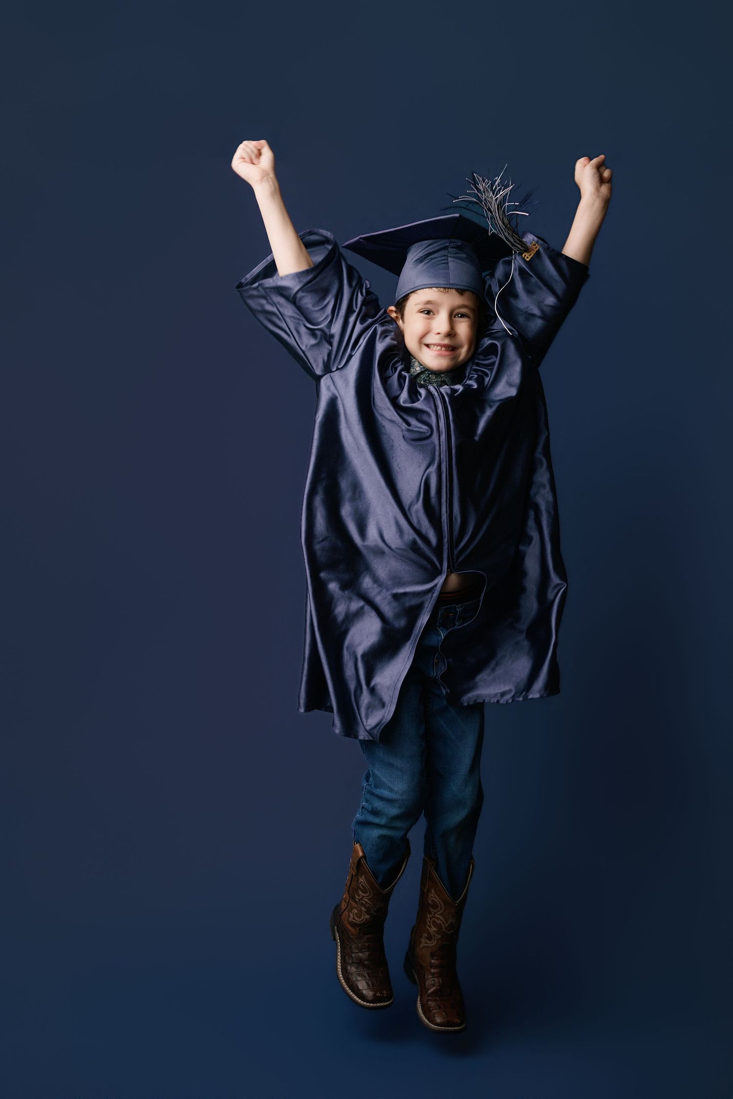 Kinder graduation portrait session with cap and gown in Port Neches, TX with Bree Elle Photography.