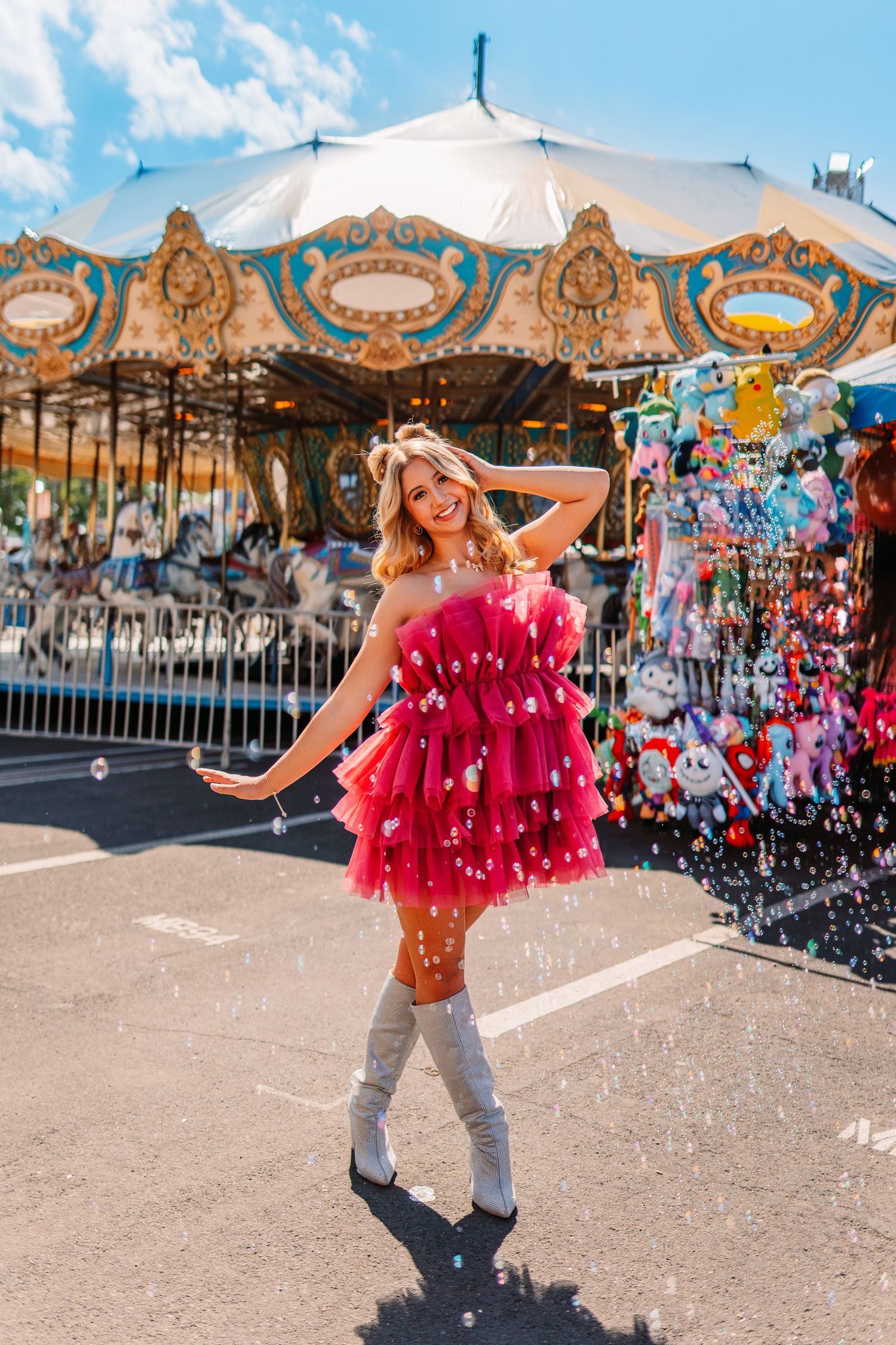 A festive carnival scene with a carousel and bright blue sky in the background.
