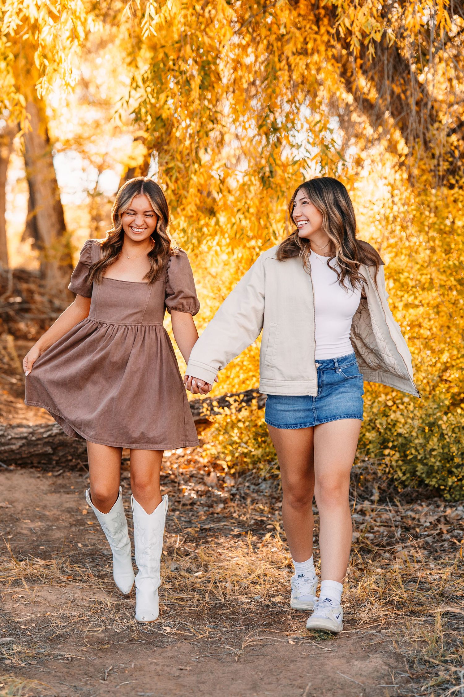 Friends in casual outfits walking together through an autumn scene with golden trees.