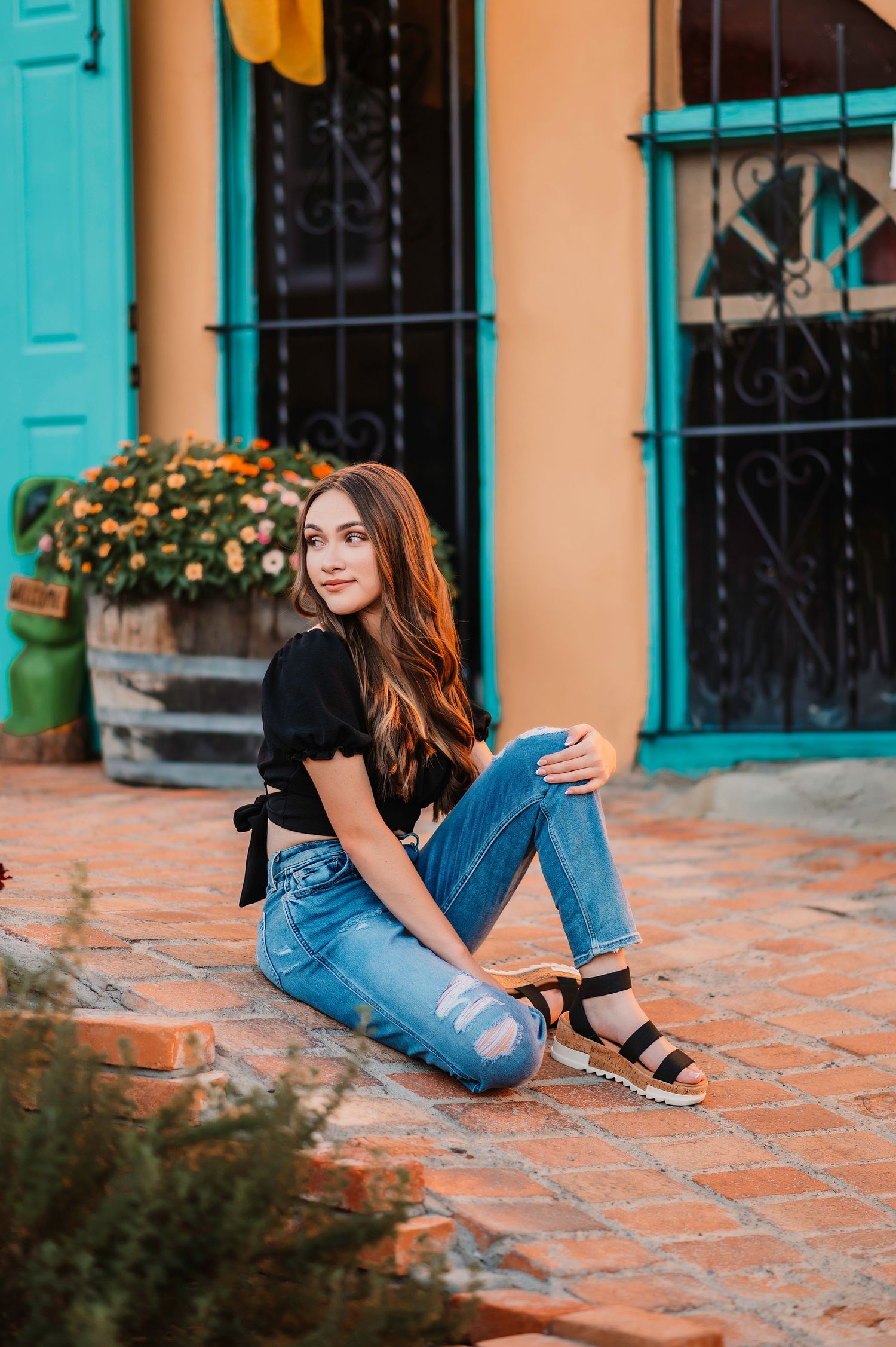 Portrait session on terracotta tiles with turquoise accents and southwestern architecture.