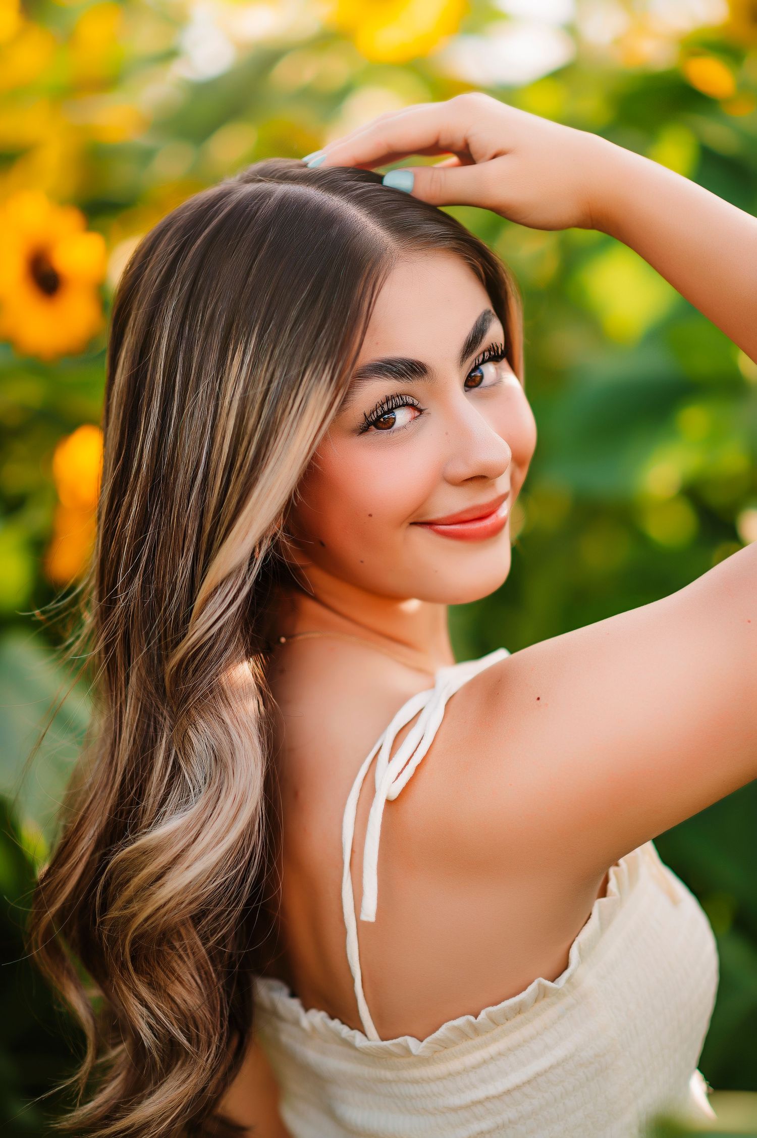 Outdoor photoshoot in a sunflower field featuring summer fashion and natural lighting.
