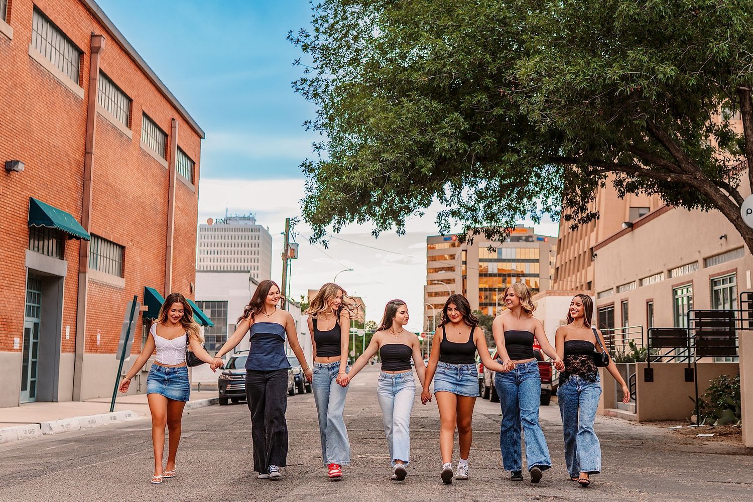 Friends in casual outfits walking together along a brick building exterior.downtown Albuquerque
Bosque / cottonwoods