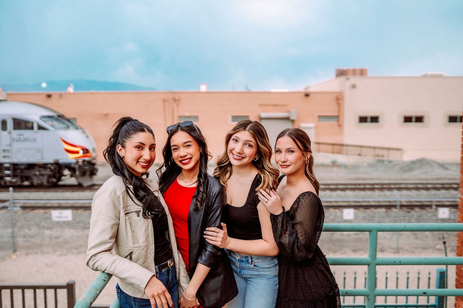 Casual group photo session on an urban rooftop with industrial backdrop.