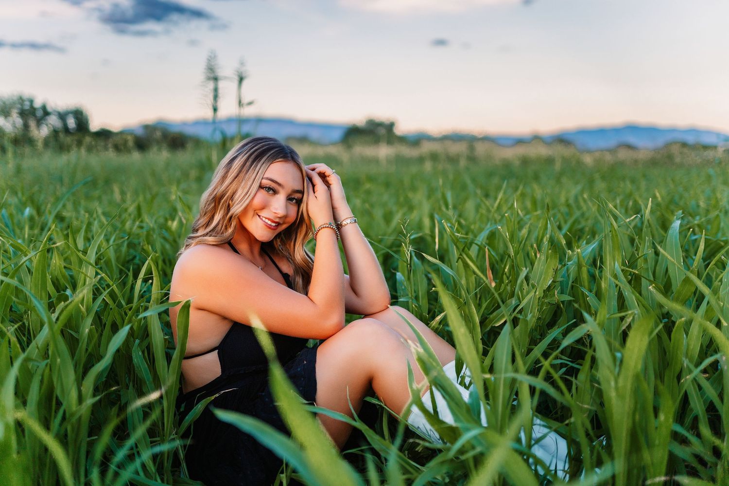 Outdoor portrait series in cornfield with natural lighting and casual summer attire.