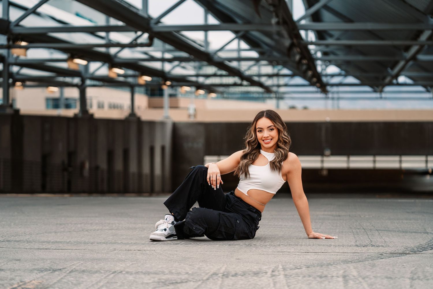 Urban photoshoot series in an industrial setting with exposed metal beams and natural lighting.