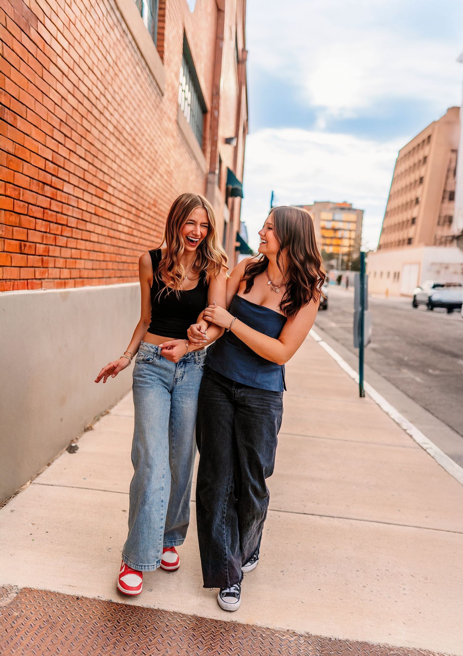 Candid shots of friends walking and laughing together on a city sidewalk.
