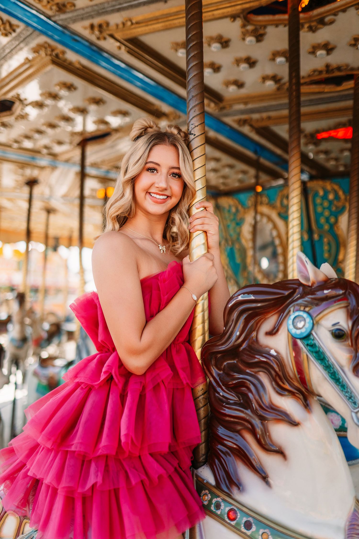 A whimsical carousel scene featuring a pink tulle dress and ornate vintage carousel horse.