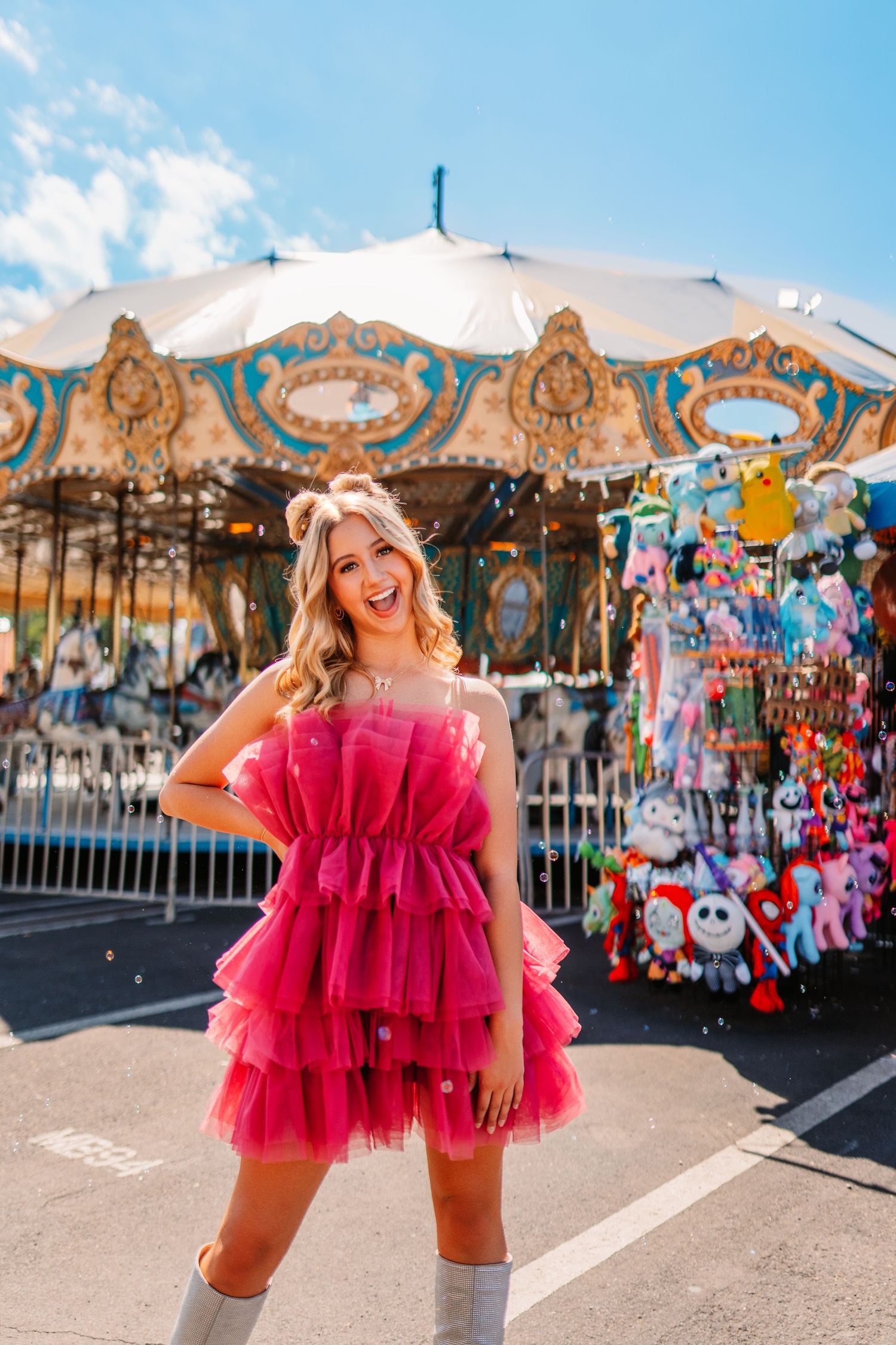 A sunny carnival day with carousel and game booths creating a festive backdrop.