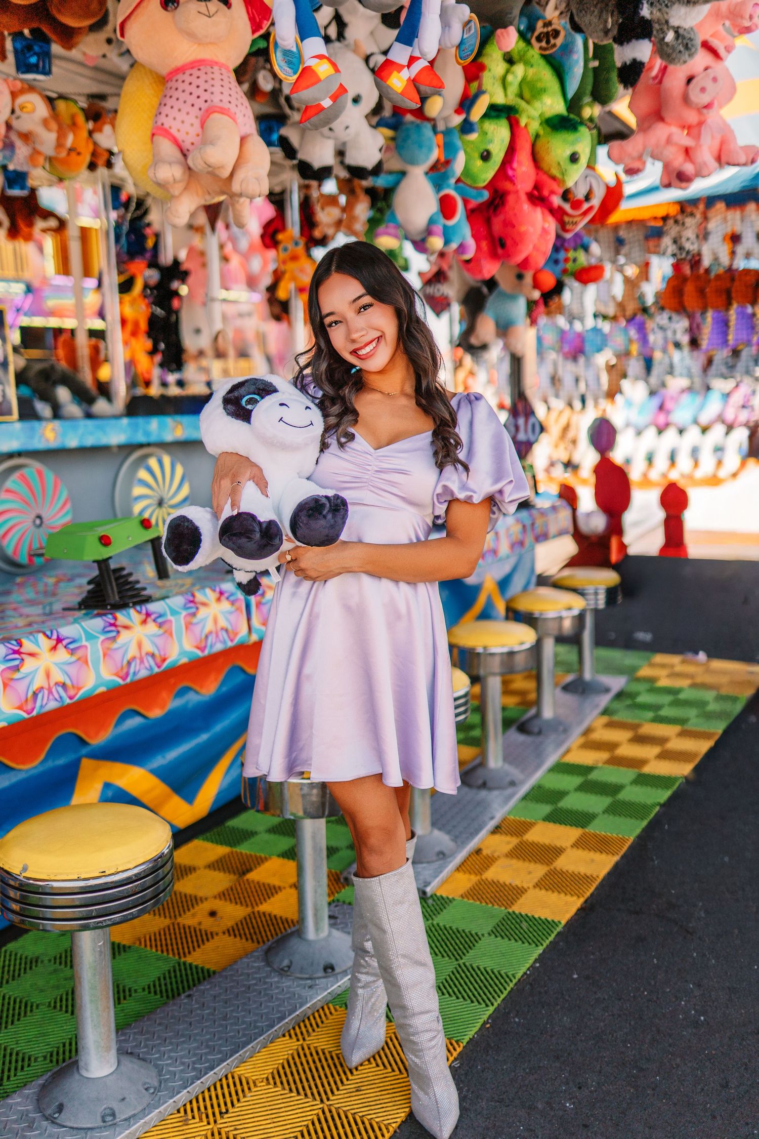 A playful scene at a carnival game booth with colorful plush toys and decorations.