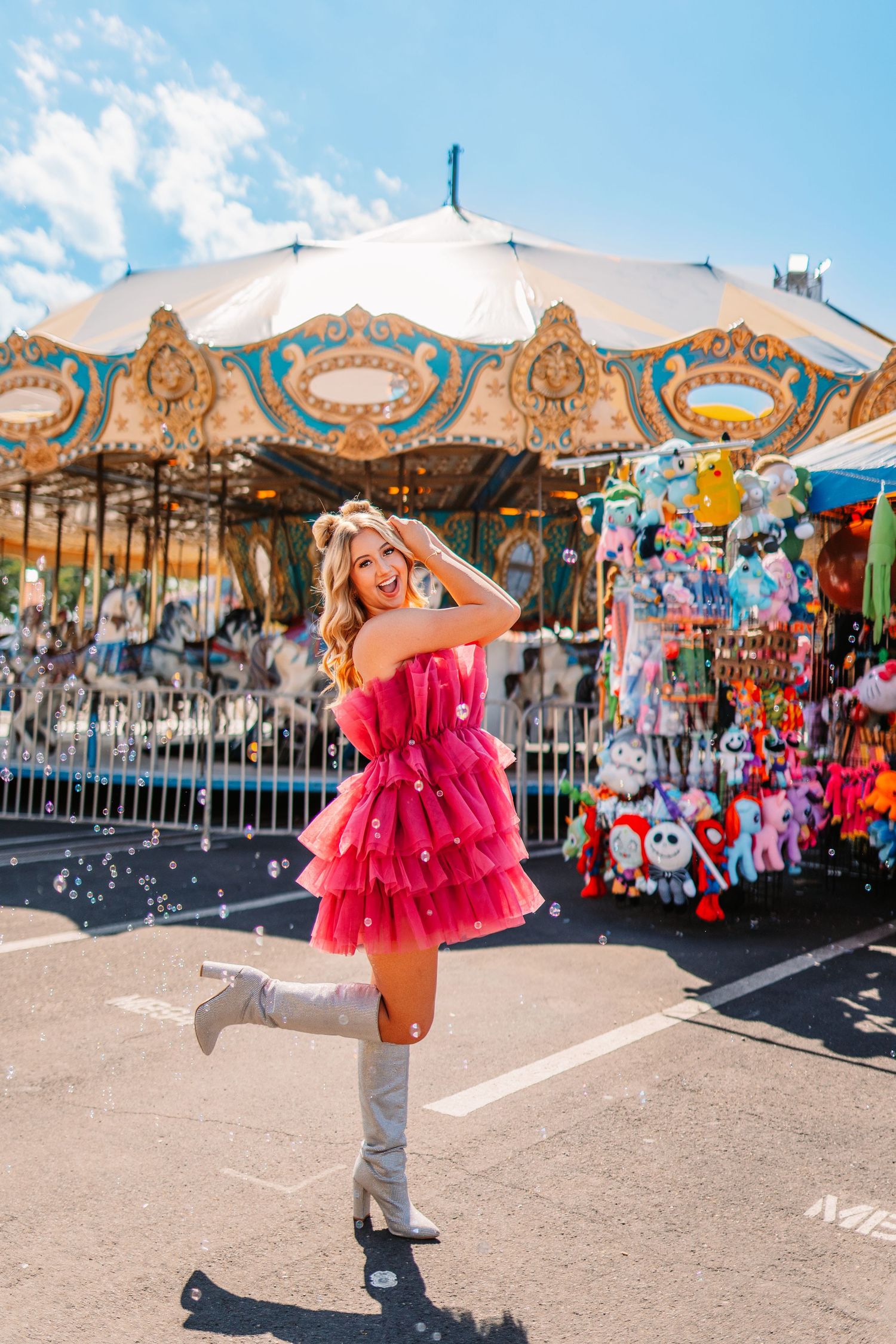 Whimsical carnival scene with classic carousel and prize stuffed animals in background.