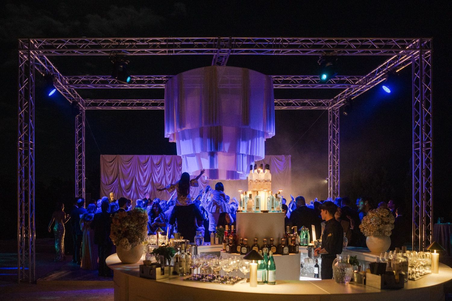 Stage lighting and truss setup for a performance venue with blue and purple illumination creating dramatic atmosphere.