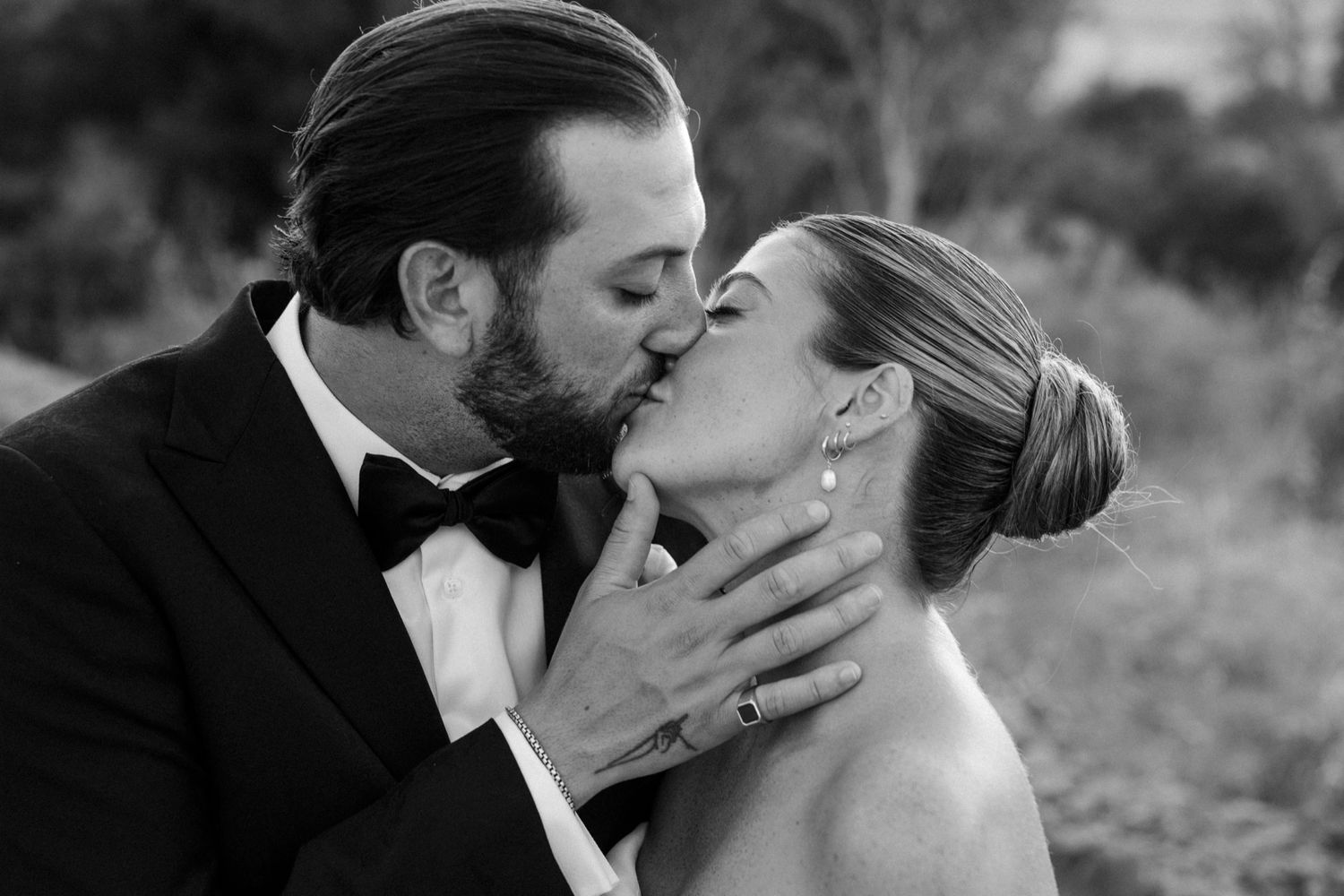 Artistic black and white close-up shots show tender moments between newlyweds.