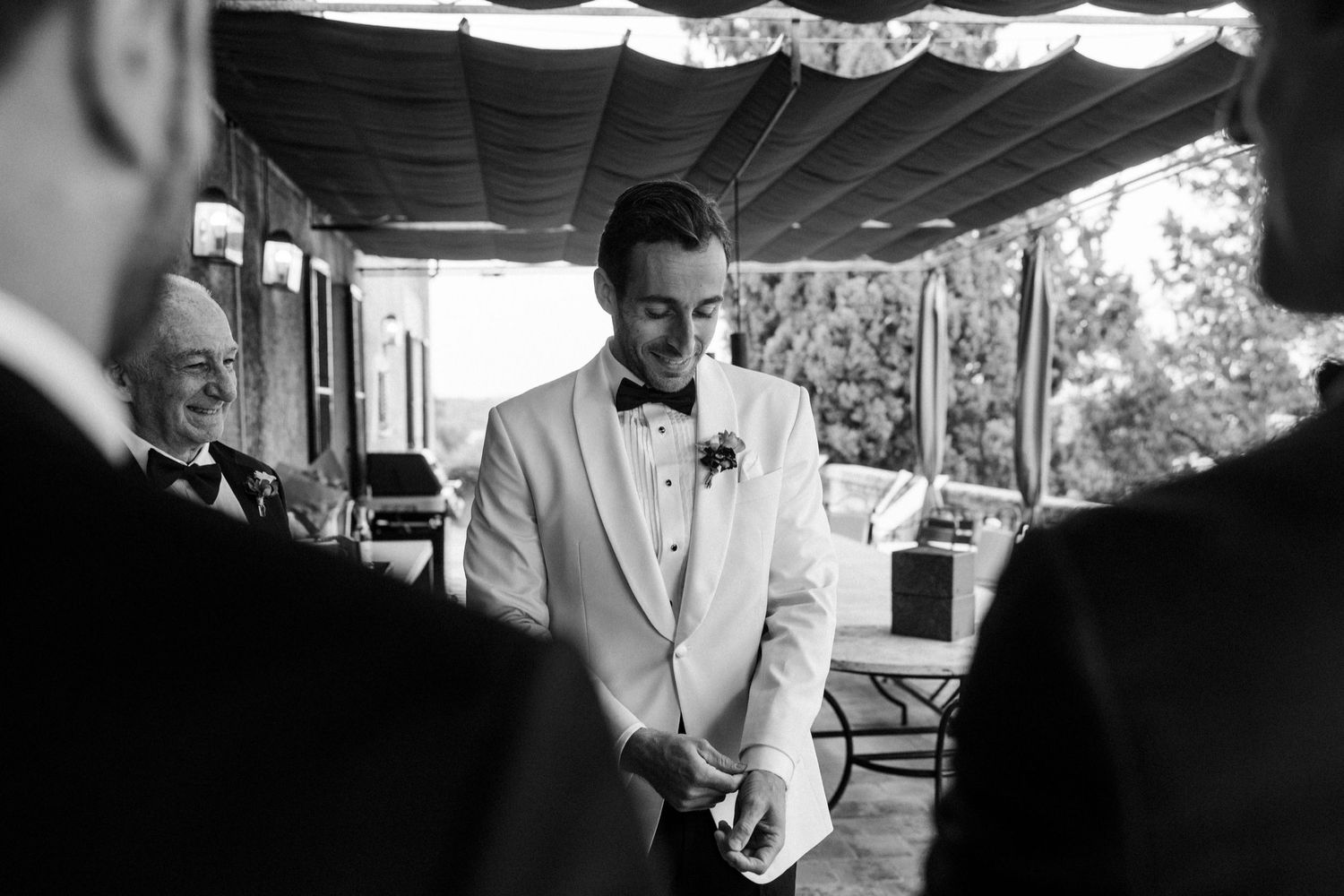 A series of black and white photos showing a person in formal attire preparing for an event.