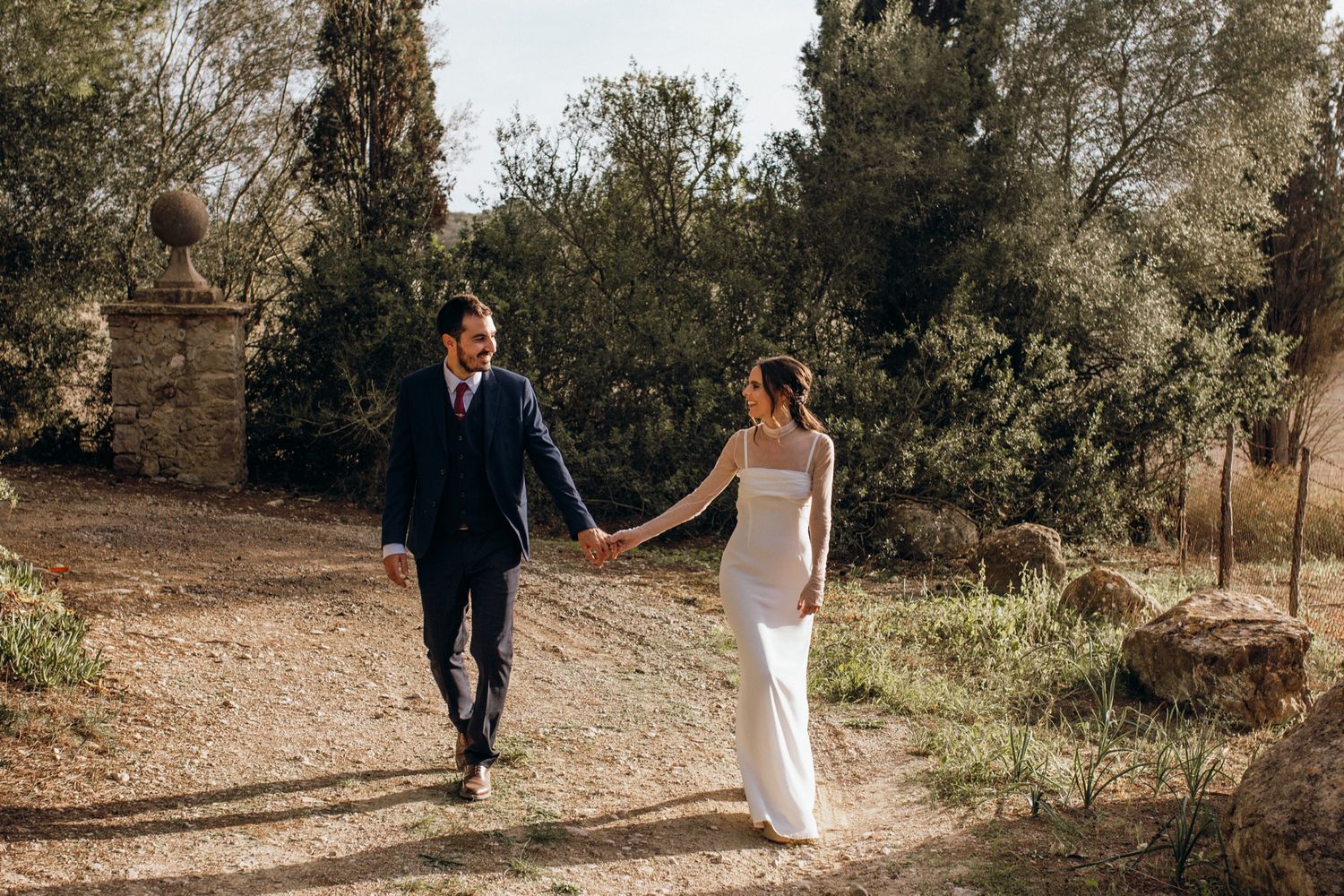 Panoramic wedding photo sequence showing couple walking through a sunlit garden path surrounded by trees.