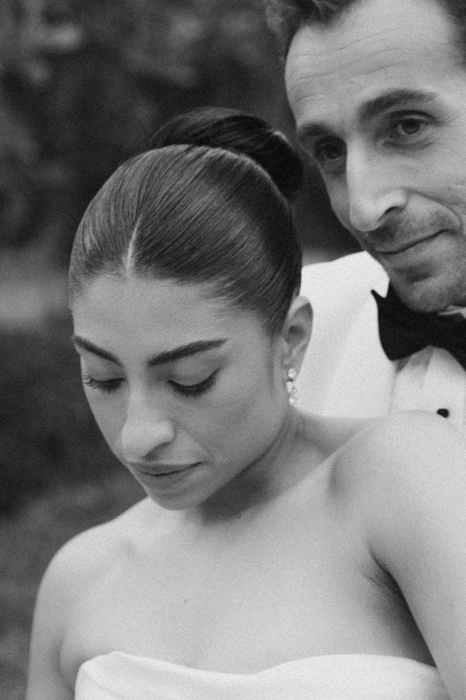 Black and white romantic photo sequence showing tender moments between a couple in wedding attire.