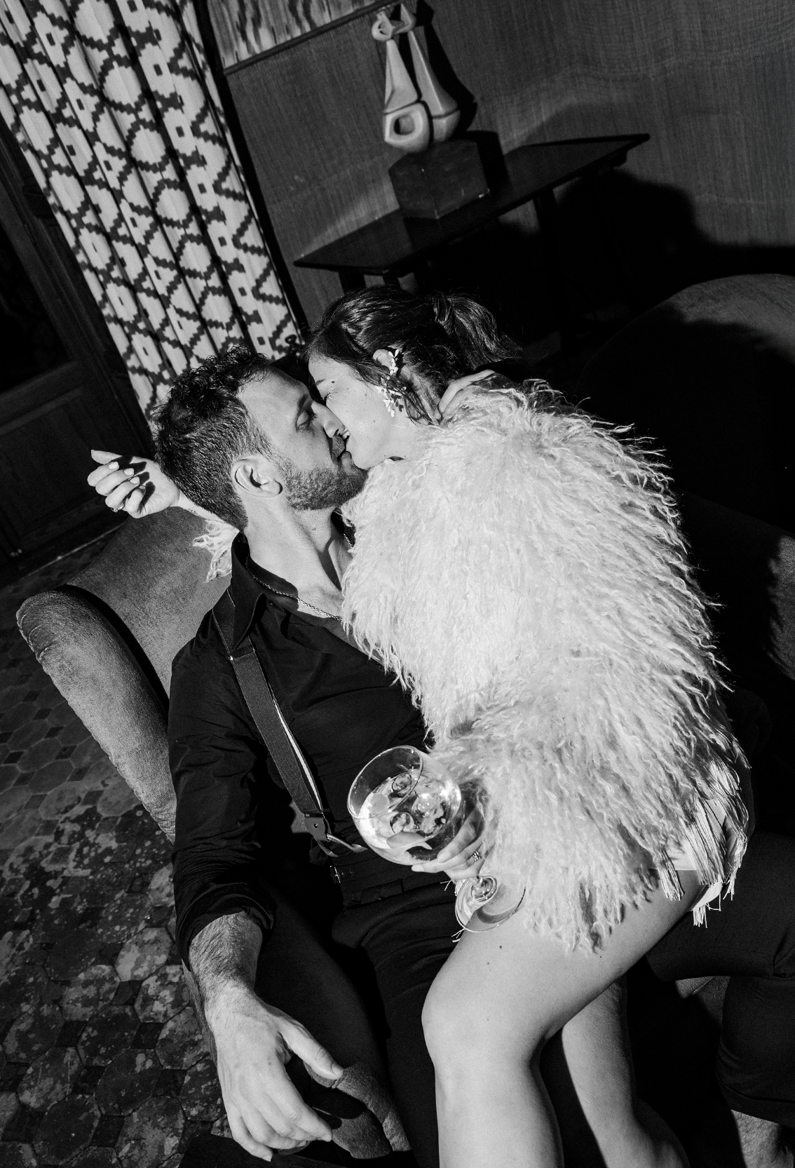 Black and white photo series showing a romantic dance sequence with feathered costume elements.